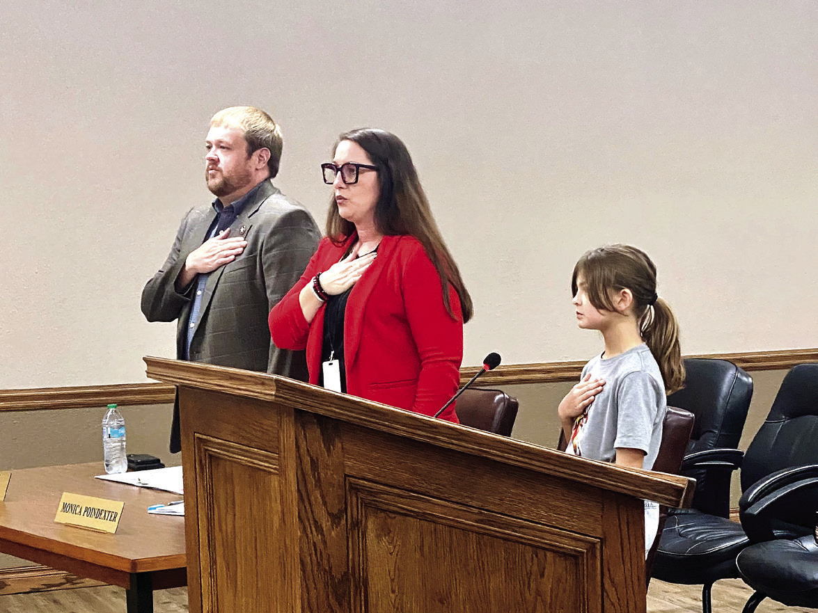 McLoud City Manager Cody Roe and Deputy Clerk Monica Poindexter recite the Pledge of Allegiance at the Aug. 28 McLoud City Council meeting. The pledge was led by special guest, 9-year-old Magnolia McClure (Mayor McClure's daughter). Julie Talton, Countywide &amp; Sun