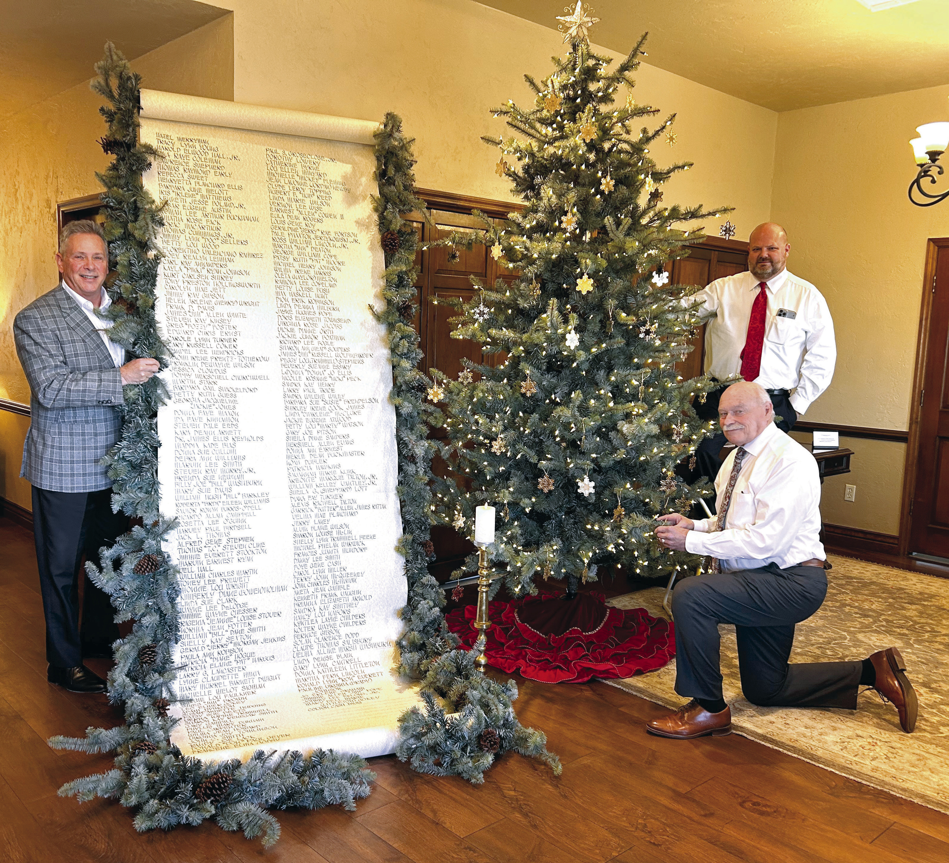 J. Cooper, Gary Schutten, and Landon Qualls pose with the Scroll of Honor and the Christmas Tree of Remembrance at Cooper Funeral Home in Tecumseh. Cooper Funeral Home will present “A Christmas Keepsake” program in the chapel for the 33rd year on Sunday, Dec. 8 at 2 pm. The families of those served by Cooper this year are invited to attend. Countywide &amp; Sun/Suzie Campbell
