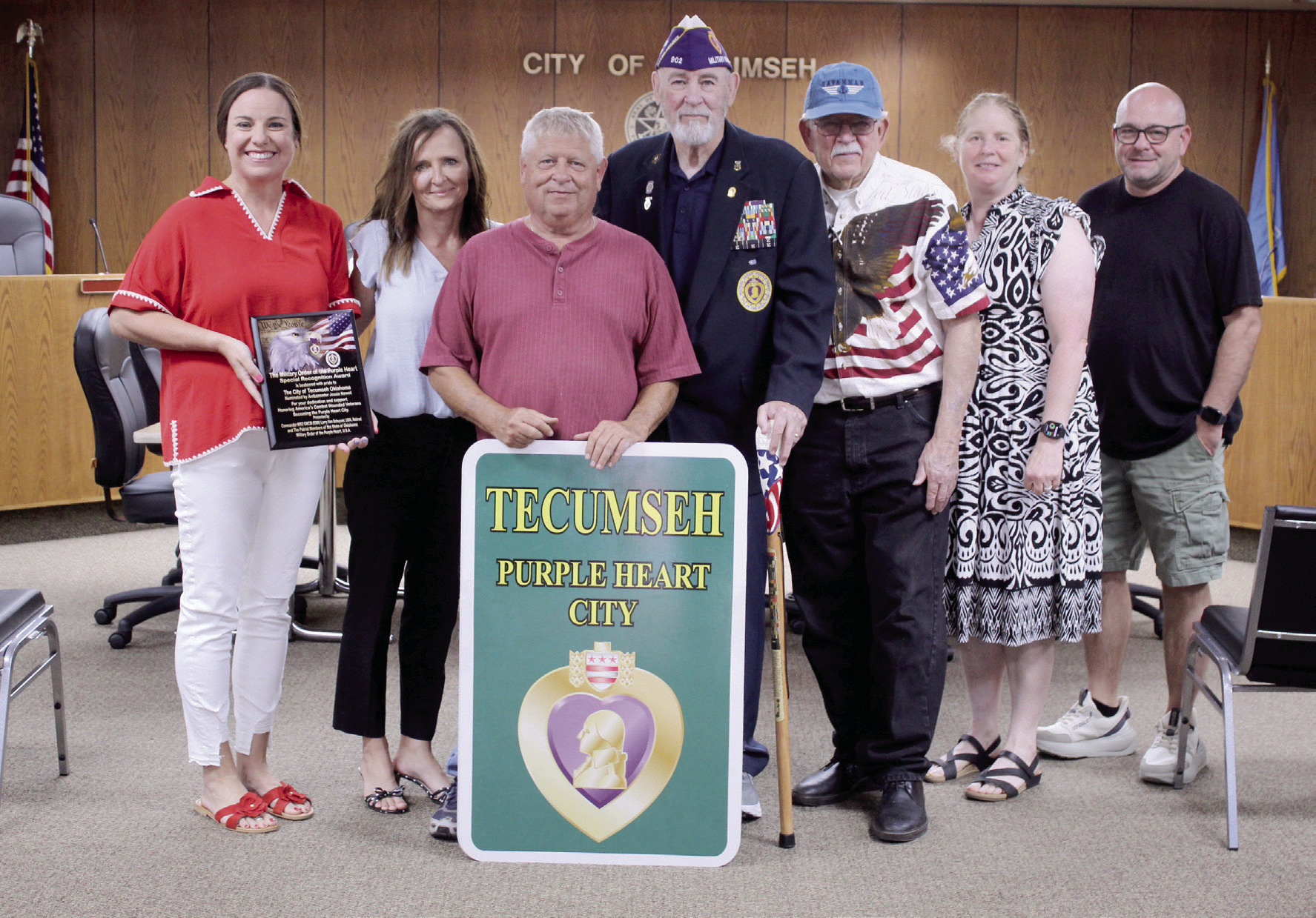 Tecumseh was officially designated as a Purple Heart City by Master Chief Larry VanSchuyver, Chapter 902 Commander of the Military Order of the Purple Heart, on Aug. 18 at Tecumseh City Hall. Shown, from left, are Natalie Arnett with State Farm Insurance; Ambassador Jessie Newell with Global Production Solutions; City Manager Jimmy Stokes; Master Chief Larry VanSchuyver; Mayor Eddy Parker; Coordinator Kacy Kinsey; and John Fletcher with Define Boutique. Arnett, Newell and Fletcher donated toward the signs. 
