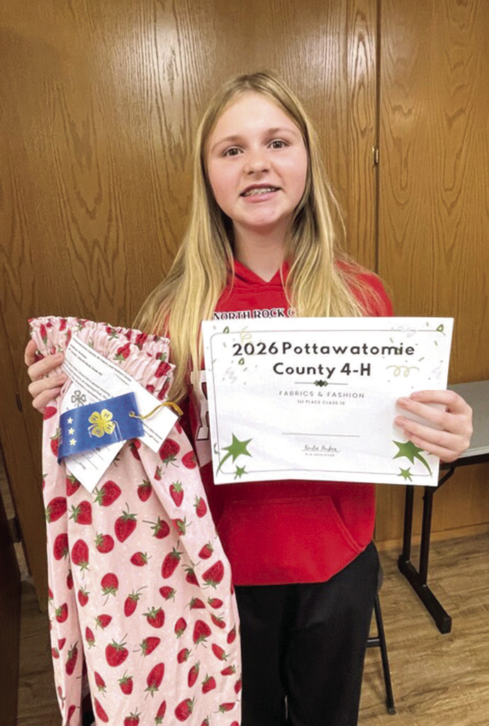 Addison Bristow holds her first place certificate alongside her strawberry patterned ribbon skirt. Photo provided by CPN