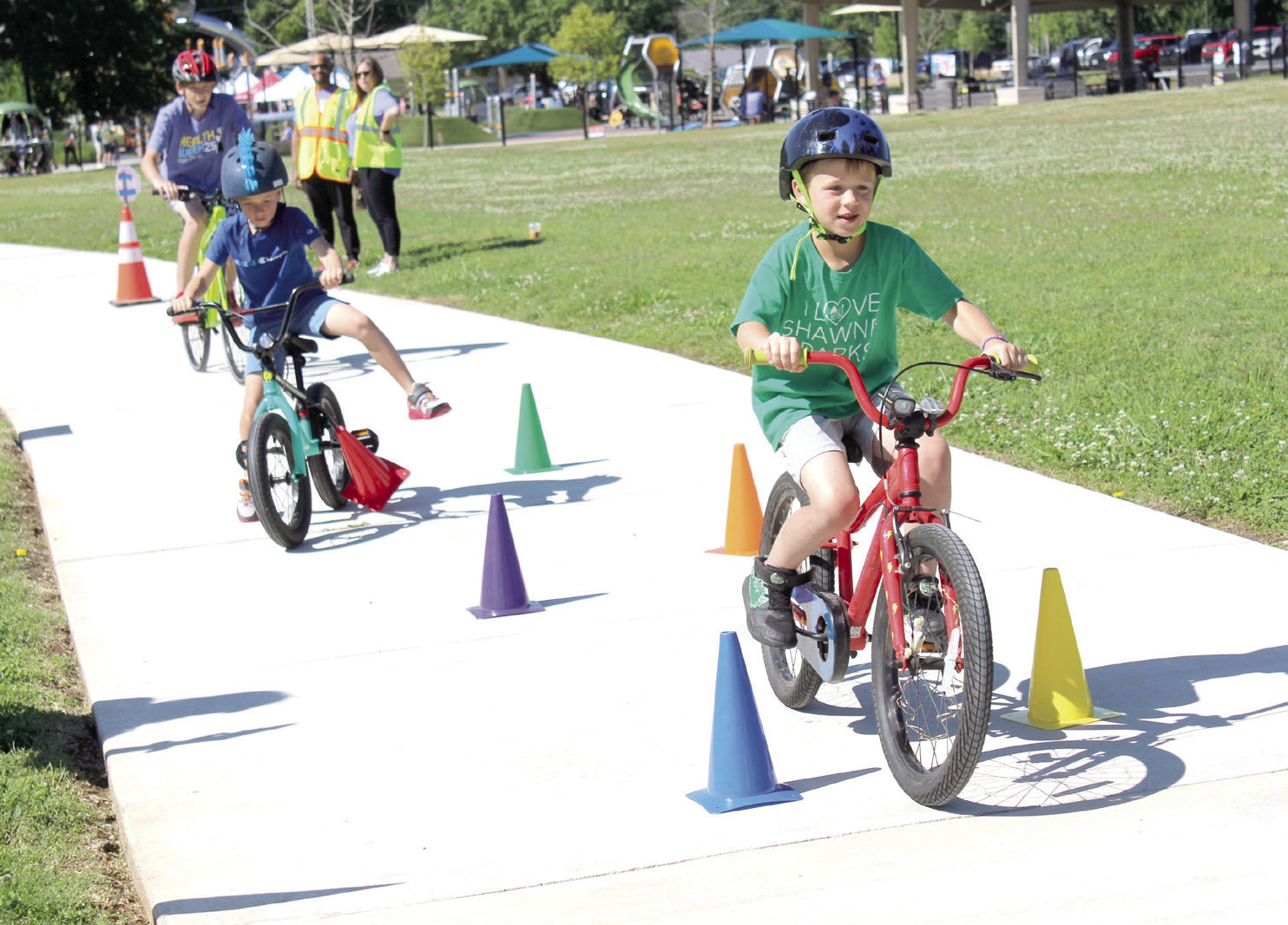 Dillon Beck, 7, of Shawnee, leads two other bicyclists during the Bike Safety Blitz at the Fun Day at Kidspace Park in Shawnee on May 30. Fun Day was part of Health Week, which is sponsored by the Avedis Foundation, and offered a variety of activities in the morning and evening. Pottawatomie Go (POGO) sponsored the bike safety event and several other events. Natasha Dunagan, Countywide &amp; Sun