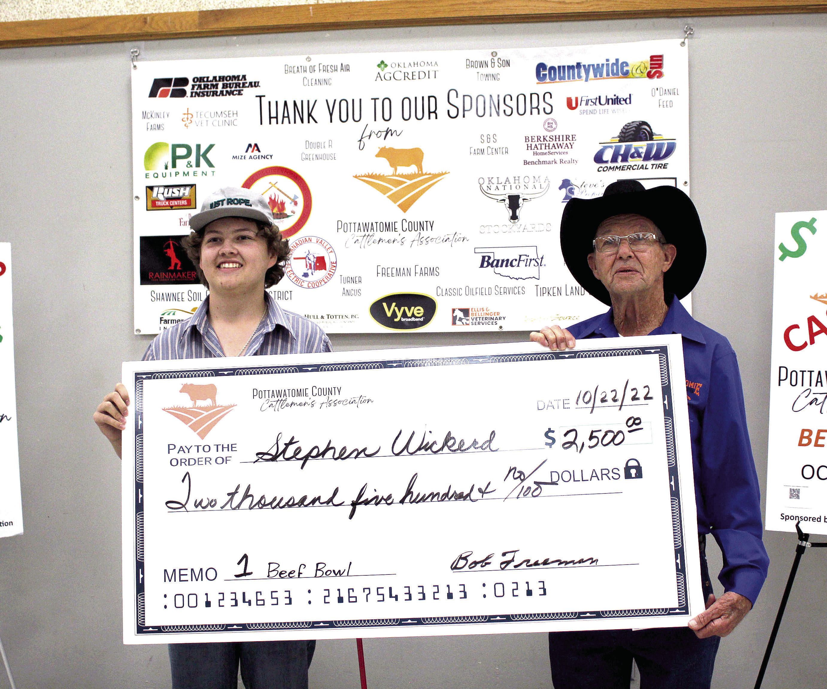 Pottawatomie County Cattlemen’s Association President Bob Freeman, right, presents an oversized check for $2,500 to North Rock Creek sophomore Stephen Wickerd, who won first place in the inaugural Beef Quiz Bowl on Oct. 22. Countywide &amp; Sun/Natasha Dunagan