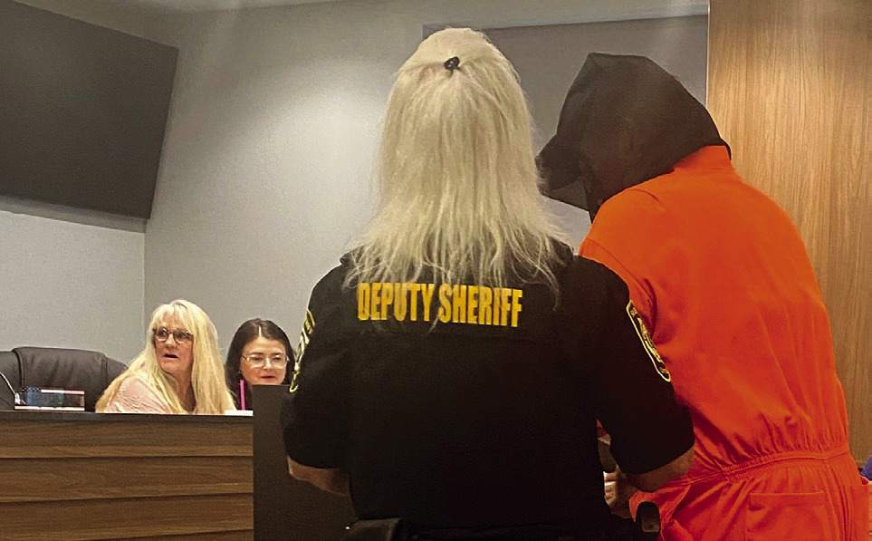 Deputy Sheriff Candie Griffin escorted her prisoner to the podium to address the commission. Clerks, Raeshel Flewallen and Stephanie Hutchcraft seemed slightly concerned. Julie Talton, Countywide & Sun