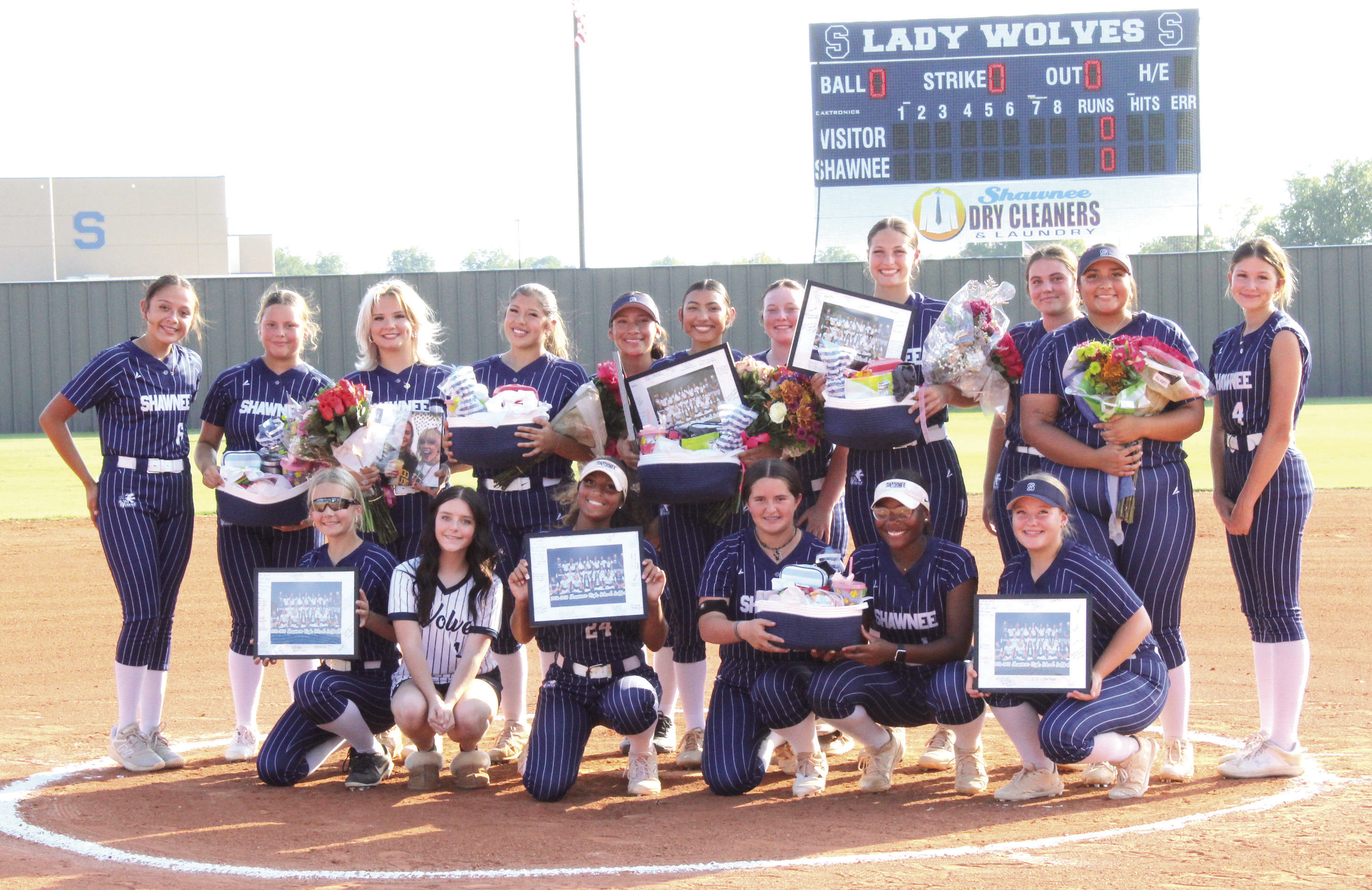 Shawnee High School celebrated their five fastpitch softball seniors before the home game on Sept. 24. Holding flowers, they include Embrie Smith, Cochana Martin, Alivia Grass, Taylor Bailey and Lybbie Pigeon, as the team presents them with gifts. Photos by Natasha Dunagan, Countywide &amp; Sun