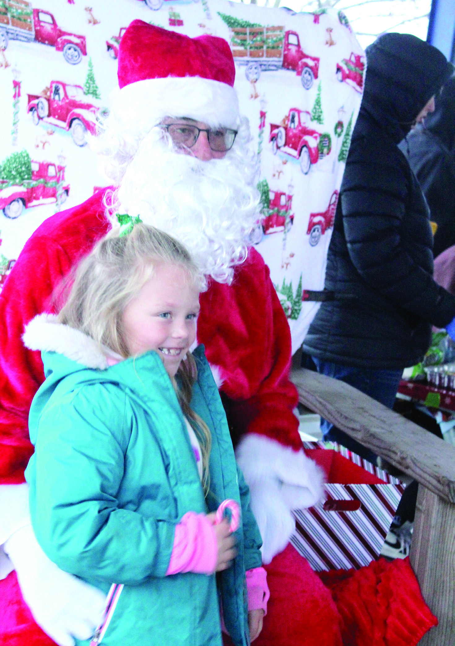 Hallie Belle Harris, 6, gets a candy cane from Santa during the Bethel Community Christmas Tree Lighting Ceremony on Dec. 7 at the Community Center Pavilion.