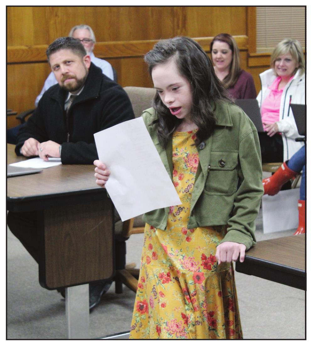 Shawnee sixth-grader Lilly Hennen reads a paragraph in the Potawatomi language and its English translation during the Shawnee Board of Education meeting on April 4. Countywide &amp; Sun/Natasha Dunagan