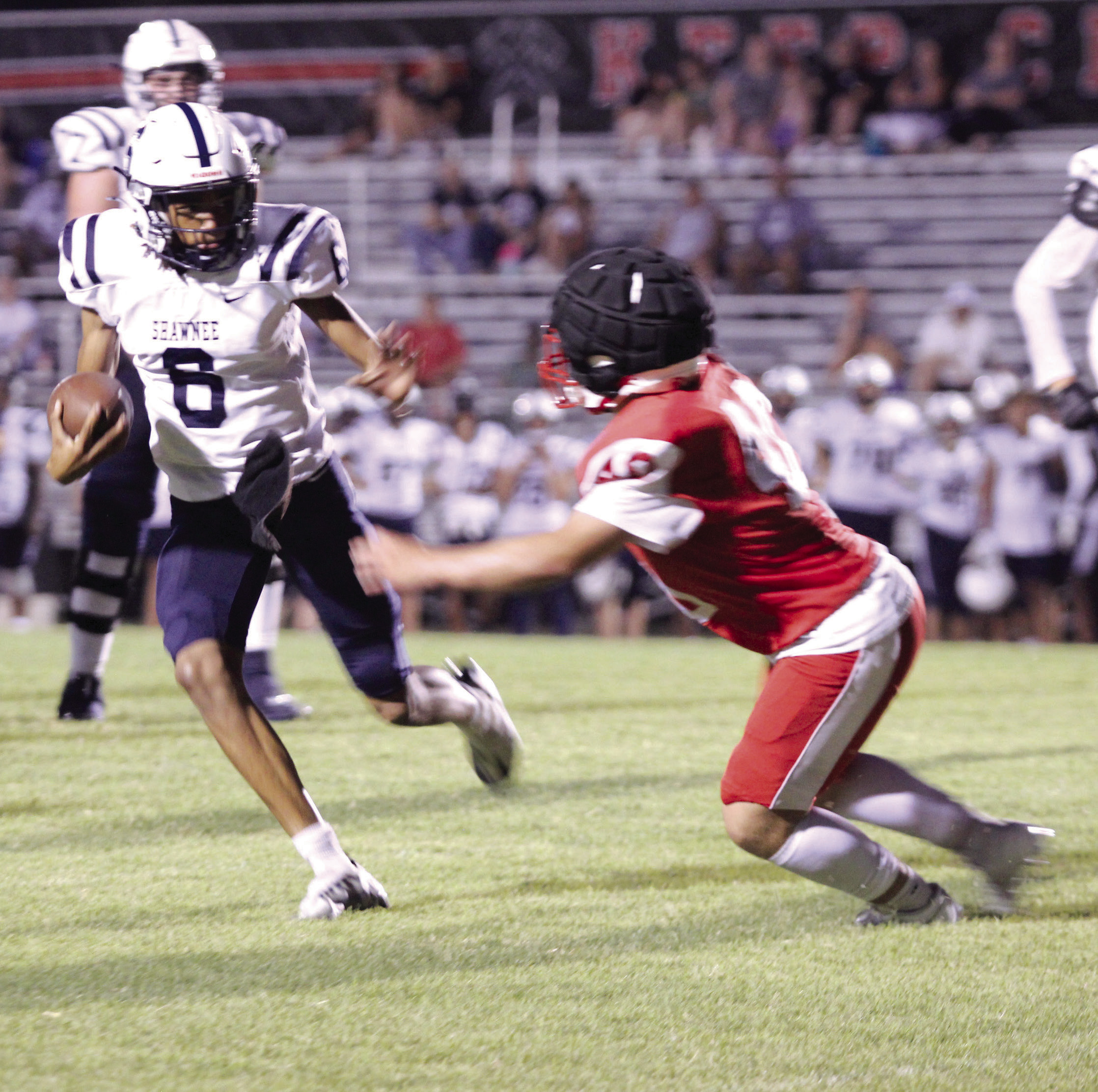 Shawnee junior Zyron Campbell deflects a McLoud defender for a first down and 20, but a call of holding made the Wolves lose yardage during the scrimmage at McLoud on Aug. 29. They played half a game, and the Redskins beat the Wolves, 19-14. Shawnee will play their first home game on Sept. 13 at 7 pm against Ardmore, and McLoud’s first home game will be Friday (Sept. 6) at 7 pm versus Harrah. Countywide & Sun/Natasha Dunagan