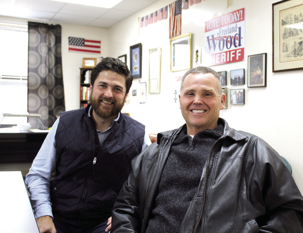 Justin Wood, the Tecumseh Public Schools Director of Community Engagement, poses with his father, Freeland Wood, who is the Pottawatomie County Sheriff Elect. F. Wood was a police officer for the City of Shawnee, Shawnee High School and North Rock Creek for 36 and a half years before winning the Sheriff’s election this year. Countywide &amp; Sun/Natasha Dunagan