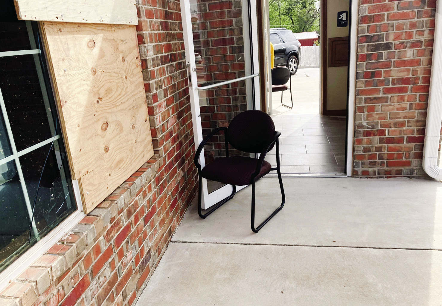 Joseph Armenta gripped the metal handle of the glass entry to Farmers Insurance on the corner of Federal and Kickapoo, while the April 19 tornado continued its path of destruction in Shawnee. Photo provided by Armento.