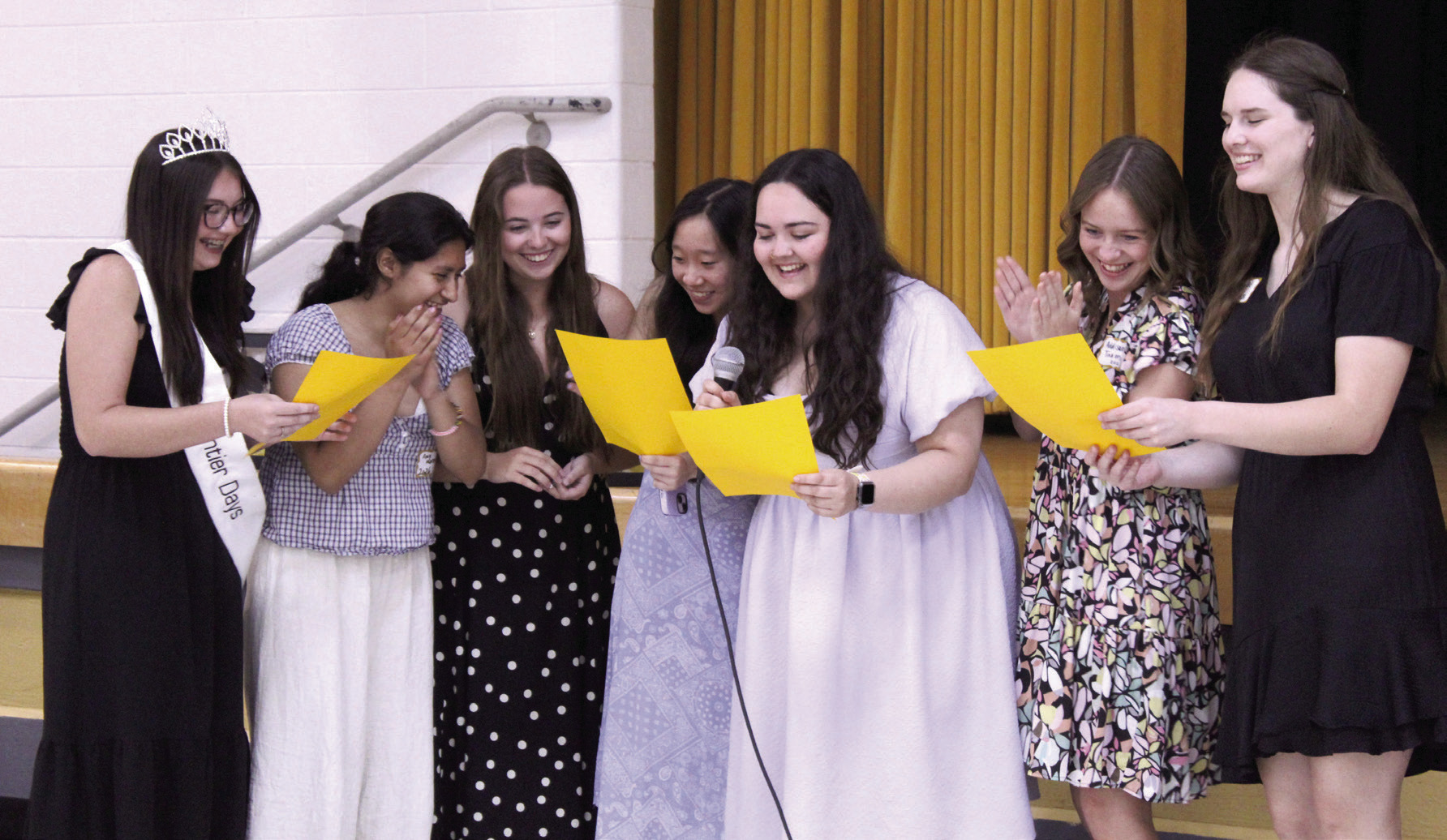 Seven Lady Savage 2026 graduates have fun leading the audience in the 'THS Fight Song' at the 124th Annual Tecumseh Alumni Banquet, held at the WP Wood THS Alumni Center on May 30. Shown, from left, are Avery Renken, Amy Moreno, Maggie Johnson, Kelsy Nguyen, Cheyanna Dietz, Addison Taron and Adalaide Lack. 