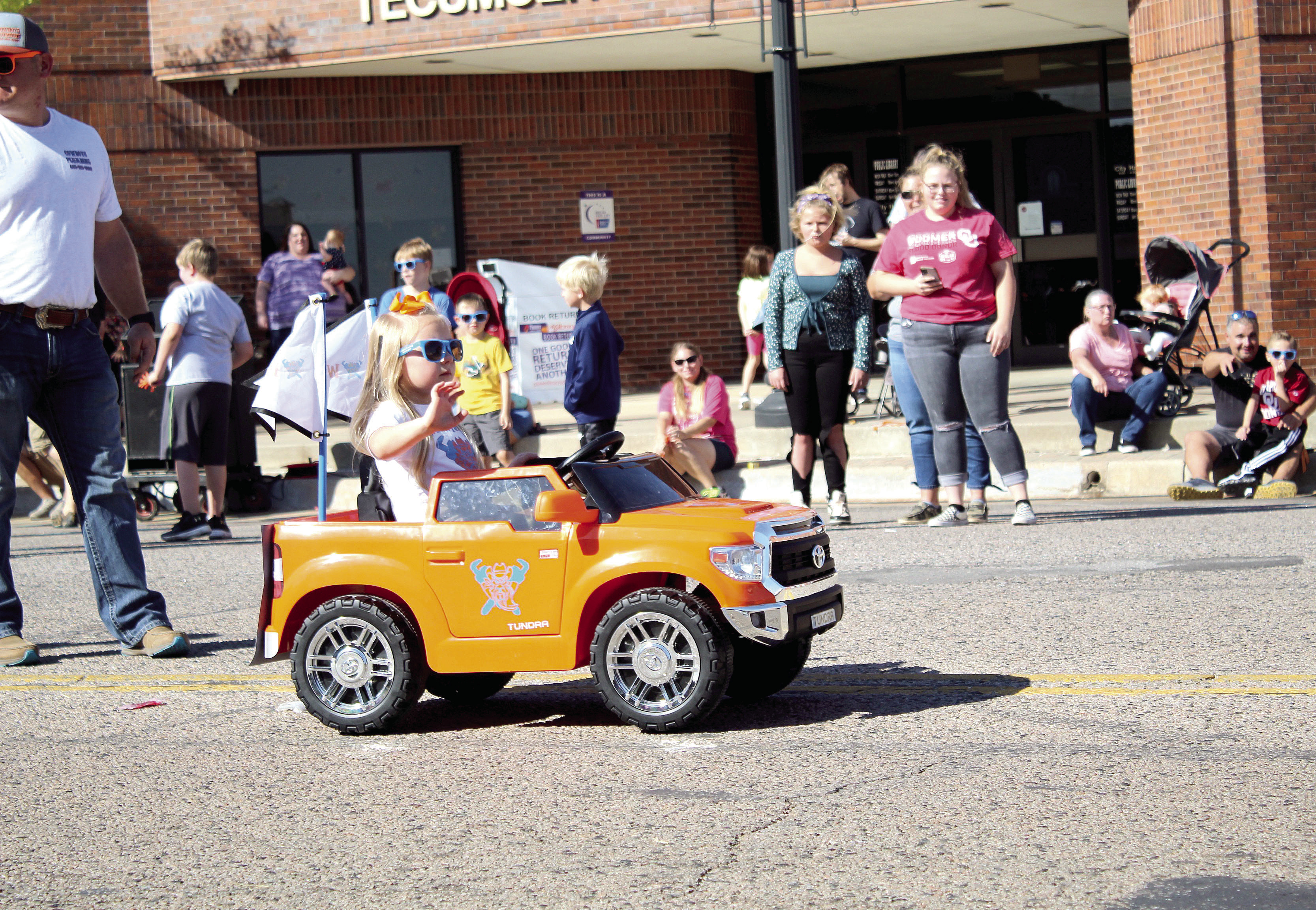 A little girl, with Cowboys Plumbing, waves from her battery-operated truck during the Frontier Days Parade on Sept. 25, 2021. Cowboys Plumbing also had a horse and buggy and a cowboy mascot in the parade. Countywide &amp; Sun/Natasha Dunagan