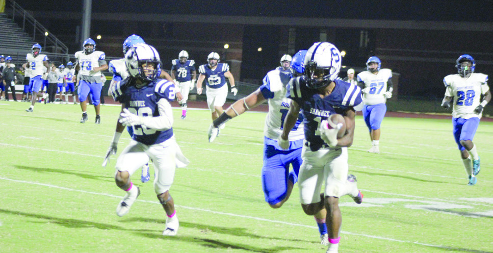 Shawnee junior Ejion Thomas carries the ball, as fellow junior Deetrick Beavers keeps an eye on the Southeast defense.
