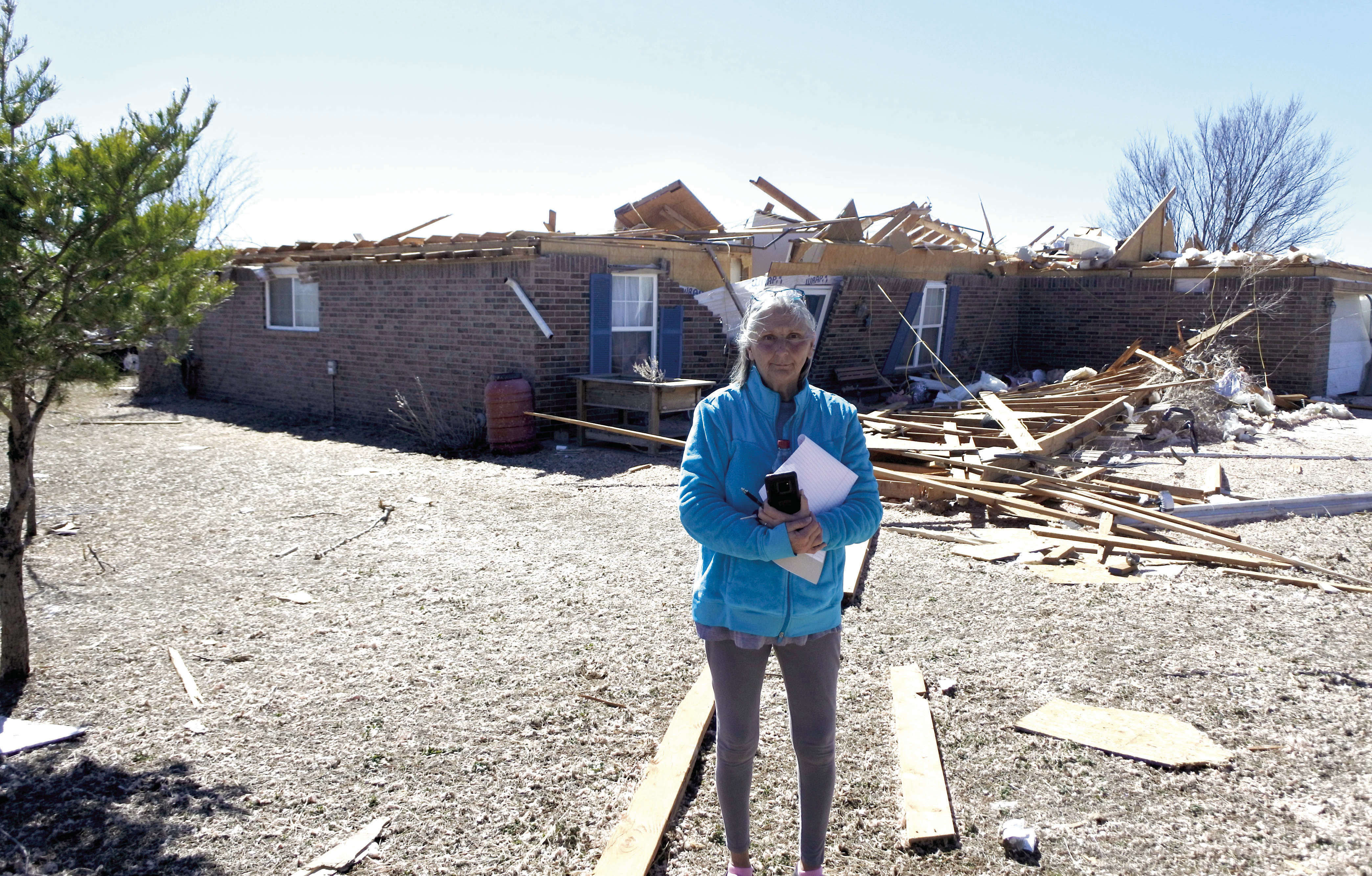 The roof is completely gone and the brick walls are crumbling, but Robyn Heard is dwelling on the positive, they are all okay. She is making note of what is salvagable and what isn’t as she and family and friends save what they can from her home Monday.