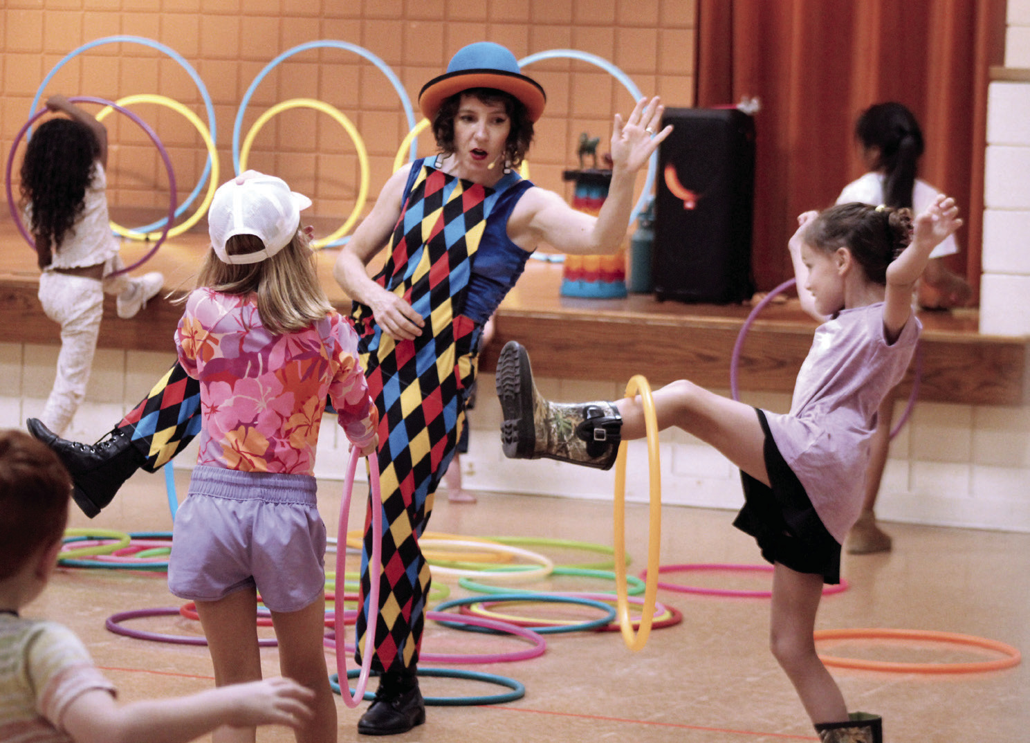 Chelsea Parks, aka "Hooplahoma," demonstrates how to spin a small hula hoop on your leg during the Tecumseh Public Library program on June 25. Photos by Natasha Dunagan, Countywide & Sun