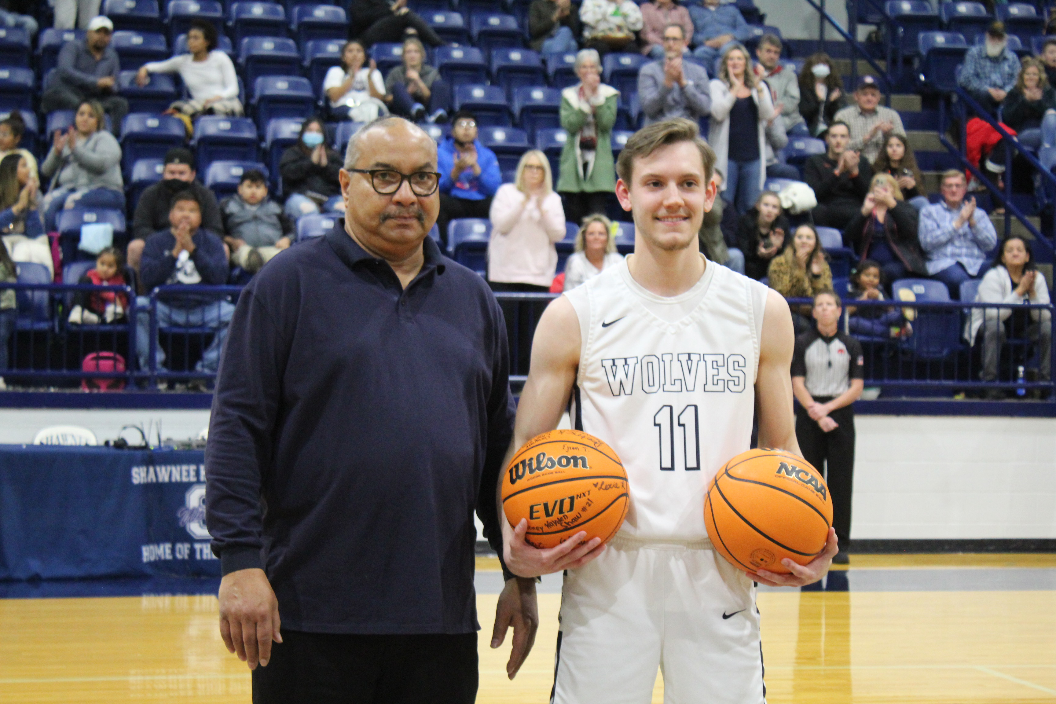 David Smith presents the Shawnee All-Time Scorer game ball to Tanner Morris.