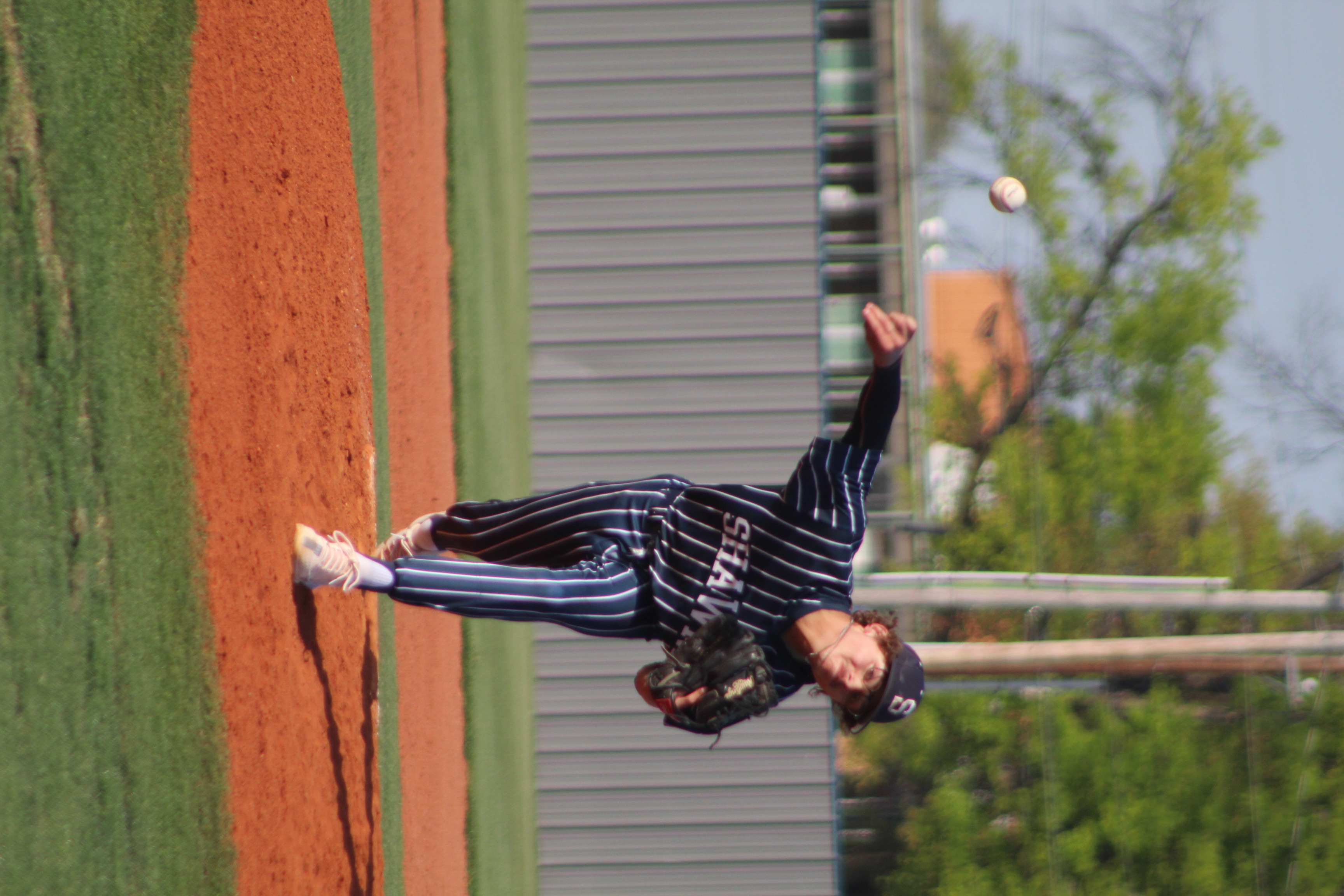 Shawnee senior Kasen Rogers launches the ball toward home plate in the third inning of the home game against Bishop Kelley on April 18. The Shawnee Wolves won, 2-1. Countywide & Sun/Natasha Dunagan