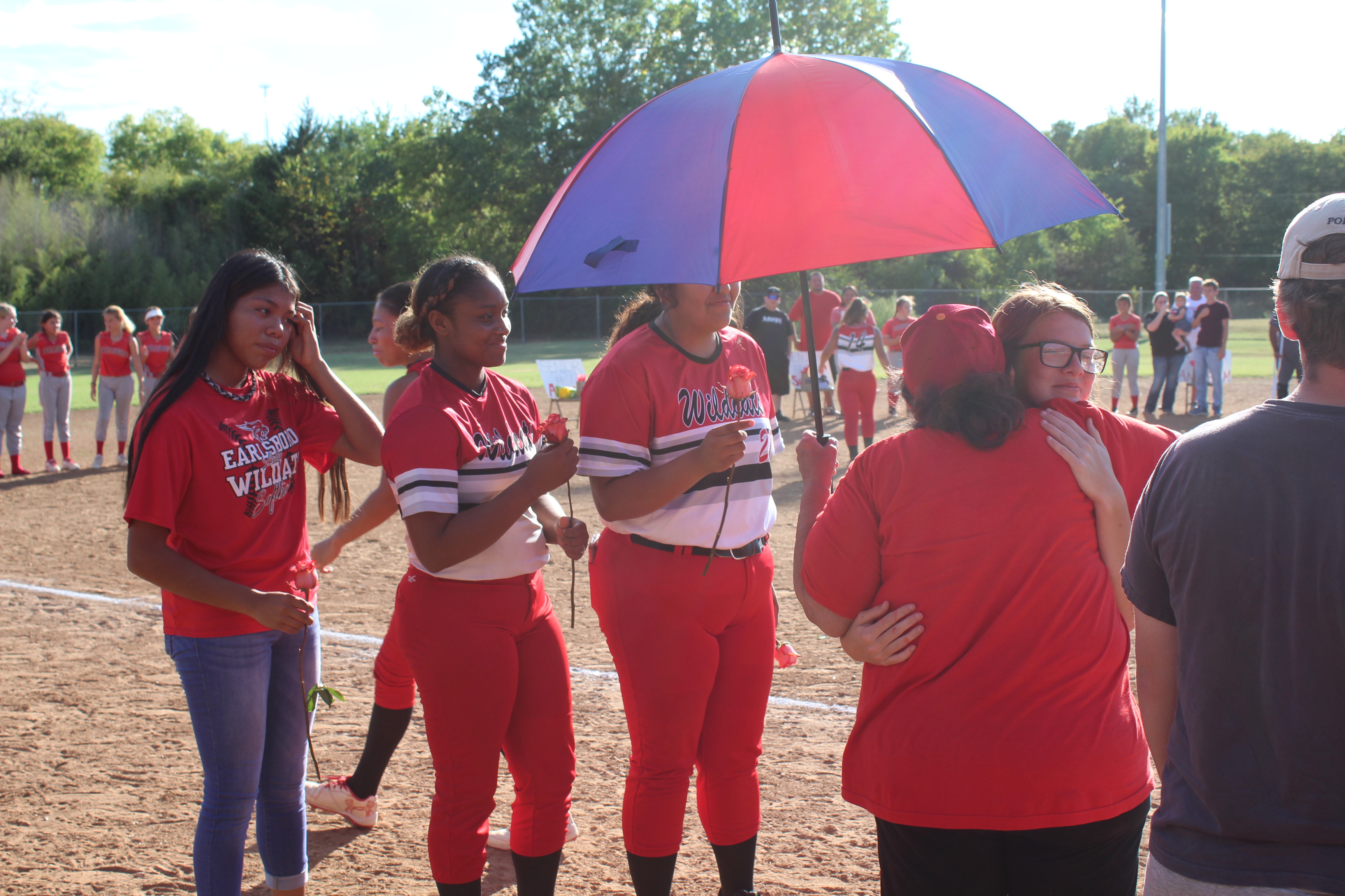 Earlsboro's Fastpitch Team "Grandma" Amelia Streater gets a hug from senior Jamie Smith during Senior Night, as Smith's teammates wait to give hugs, as well, on Sept. 20. Streater is the actual grandmother of senior Sierra Streater, and said, "I love my babies." Countywide & Sun/Natasha Dunagan