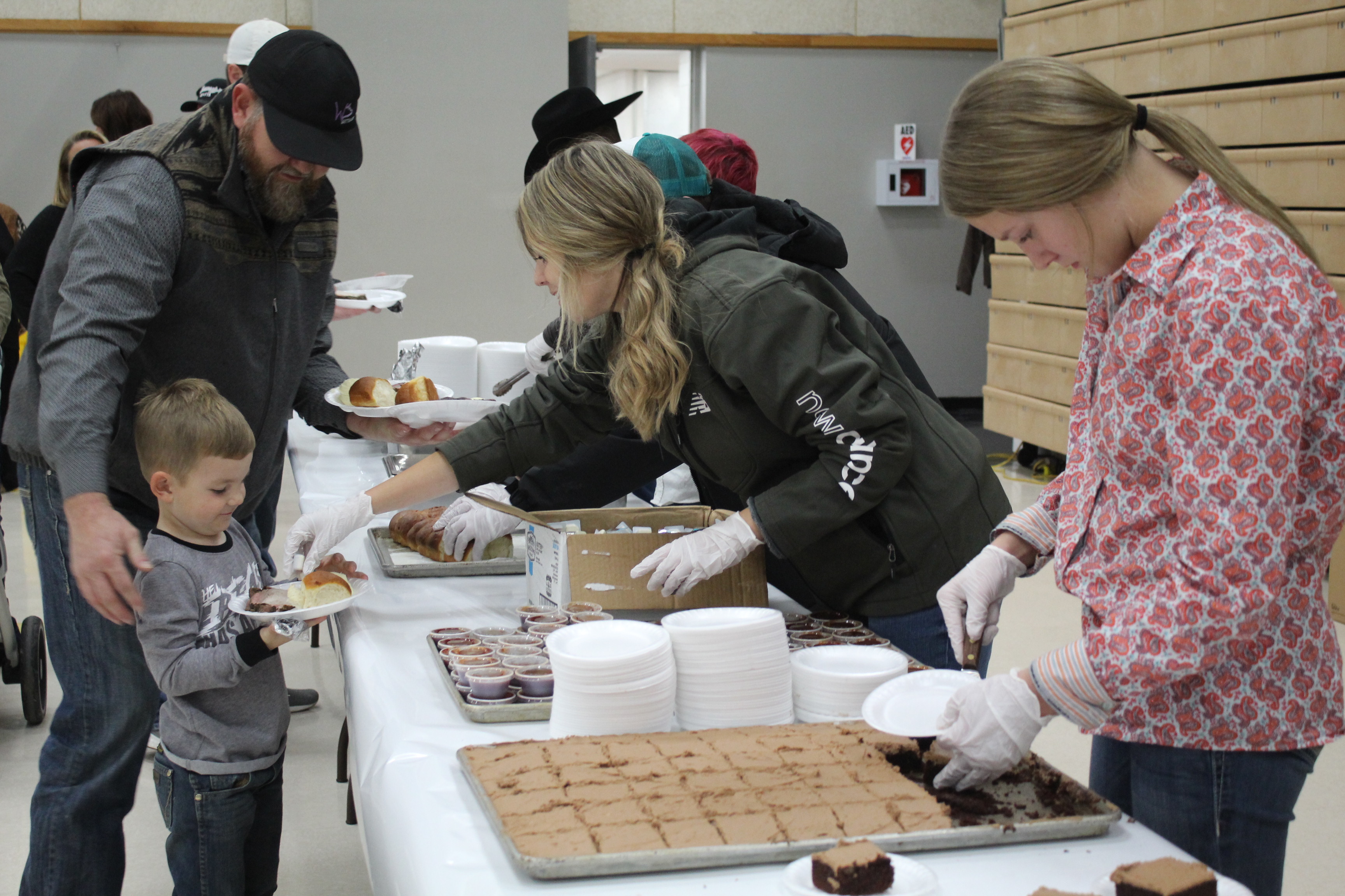 Tecumseh FFA eighth-grader Milie Esquivel serves a little boy beans as Rylee Chaffin dishes up chocolate cake during the Annual Pig Roast at Tecumseh High School’s Alumni Center on Nov. 18. According to a post on the Tecumseh FFA Facebook page, they had a “tremendous crowd and raised a record amount.” Countywide & Sun/Natasha Dunagan