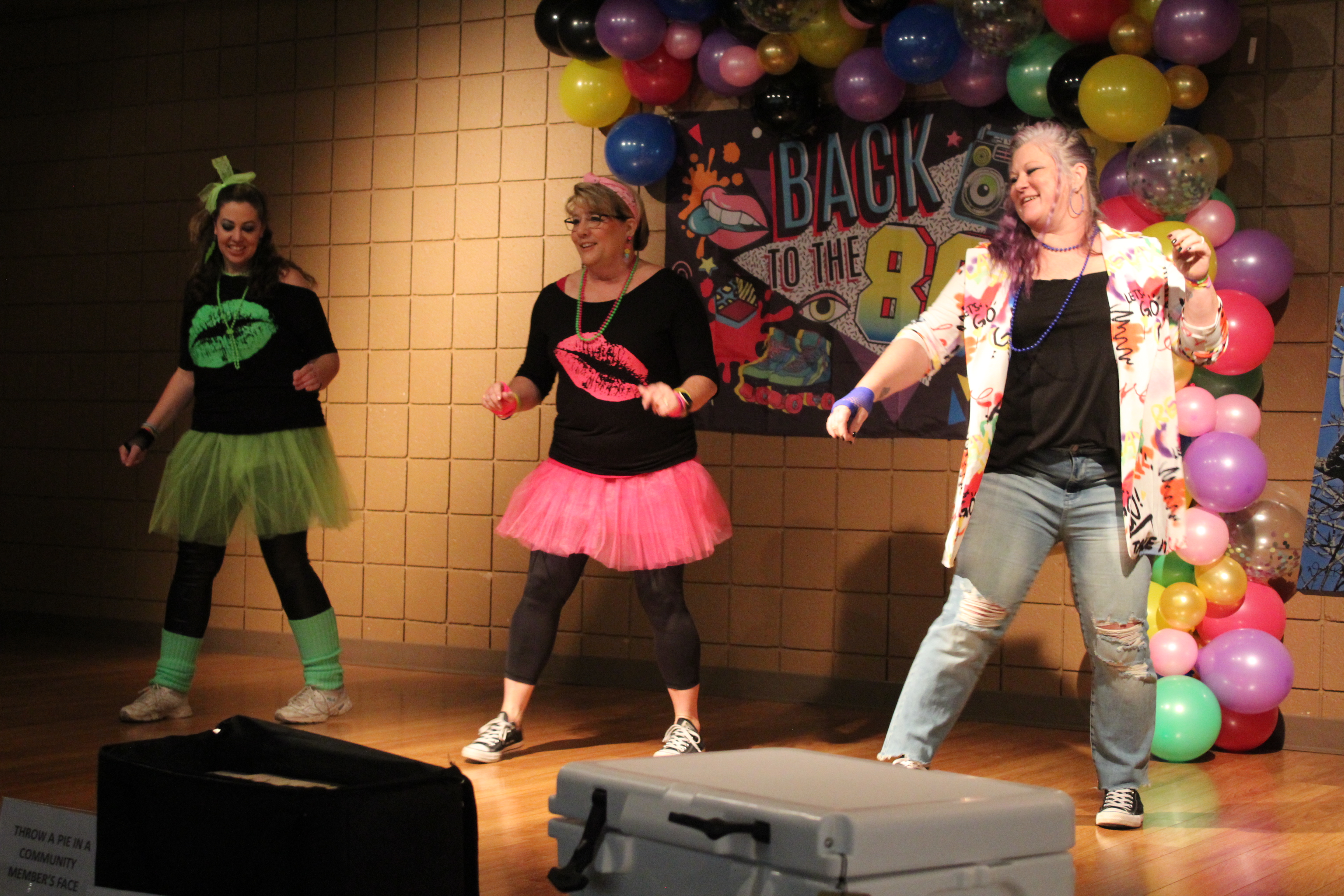 Tecumseh Chamber of Commerce Event Chair Becky Webb, Board President Kellie Clay, and Executive Director Kimberly Elliott dance to “Footloose” during the Annual Auction on Feb. 23. The theme for the event was “Back to the 80s.”