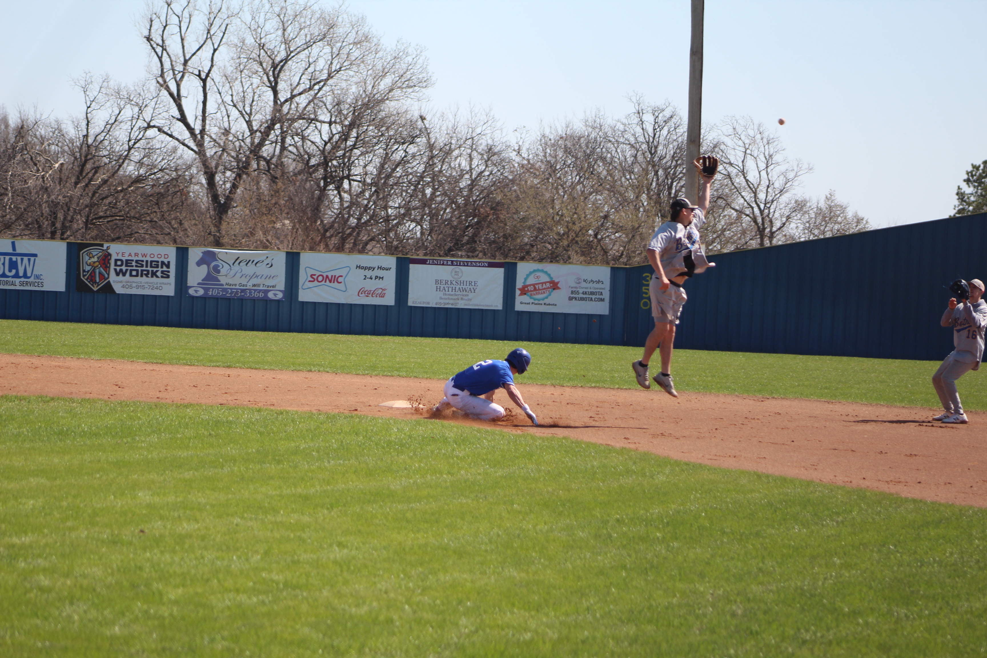 Bethel Alum L.W. Moore, Class of 2021, jumps to catch the ball, as Bethel sophmore Bryce Tapley steals second base during the Bethel Baseball Bash game between this year's team and the alumni team on March 4. The baseball season kick-off event also offered a bounce house and food truck. Bethel's first official game was March 6. Countywide & Sun/Natasha Dunagan