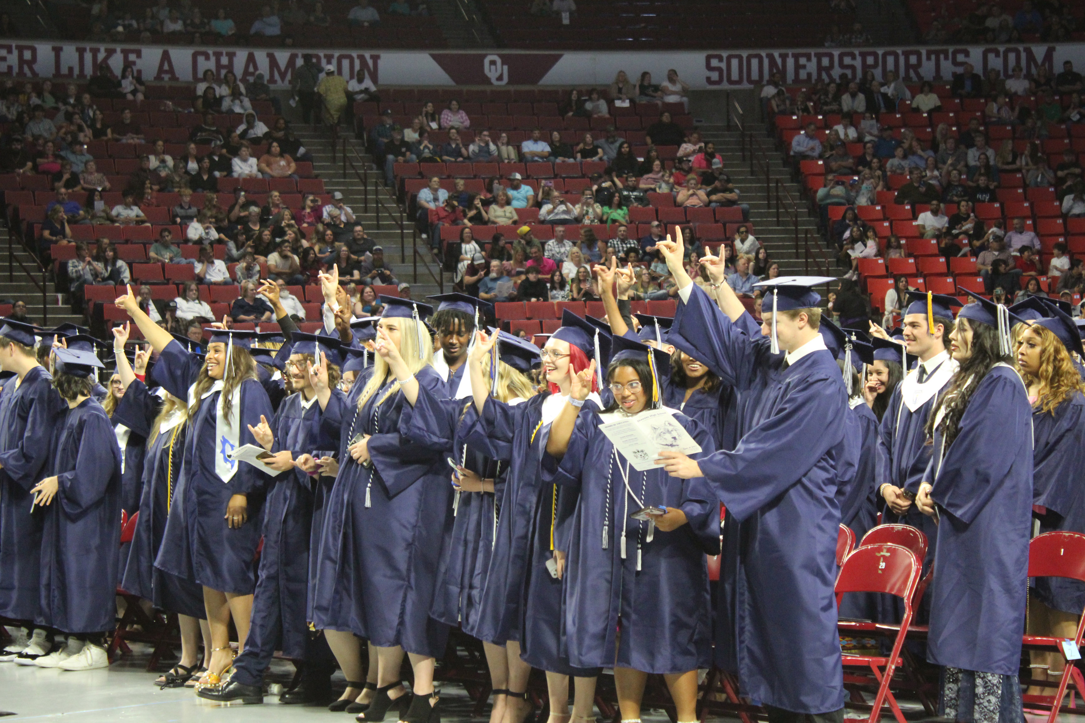 The Shawnee Class of 2023 holds up wolf signs as "Hail, Shawnee High School" is sung by members of the SHS Choir at graduation on May 18. Countywide & Sun/Natasha Dunagan