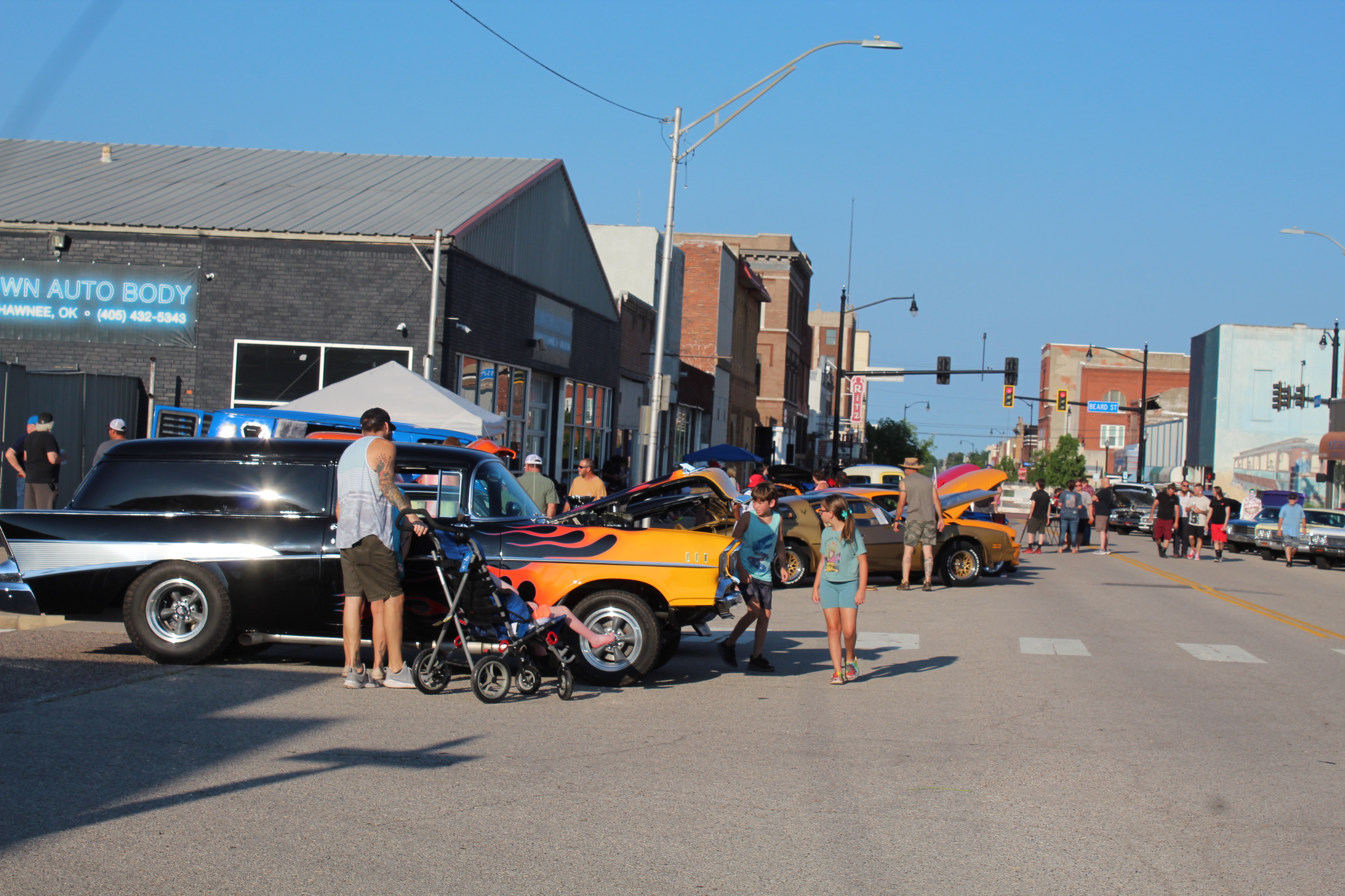People of all ages enjoy the Downtown at Sundown Car Show on Main Street in Shawnee on July 15. The fourth annual event presented by Downtown Auto Body and DTAB Customs included around 300 cars and trucks, live music by Nasty Weather, games, giveaways, and food trucks. Countywide & Sun/Natasha Dunagan