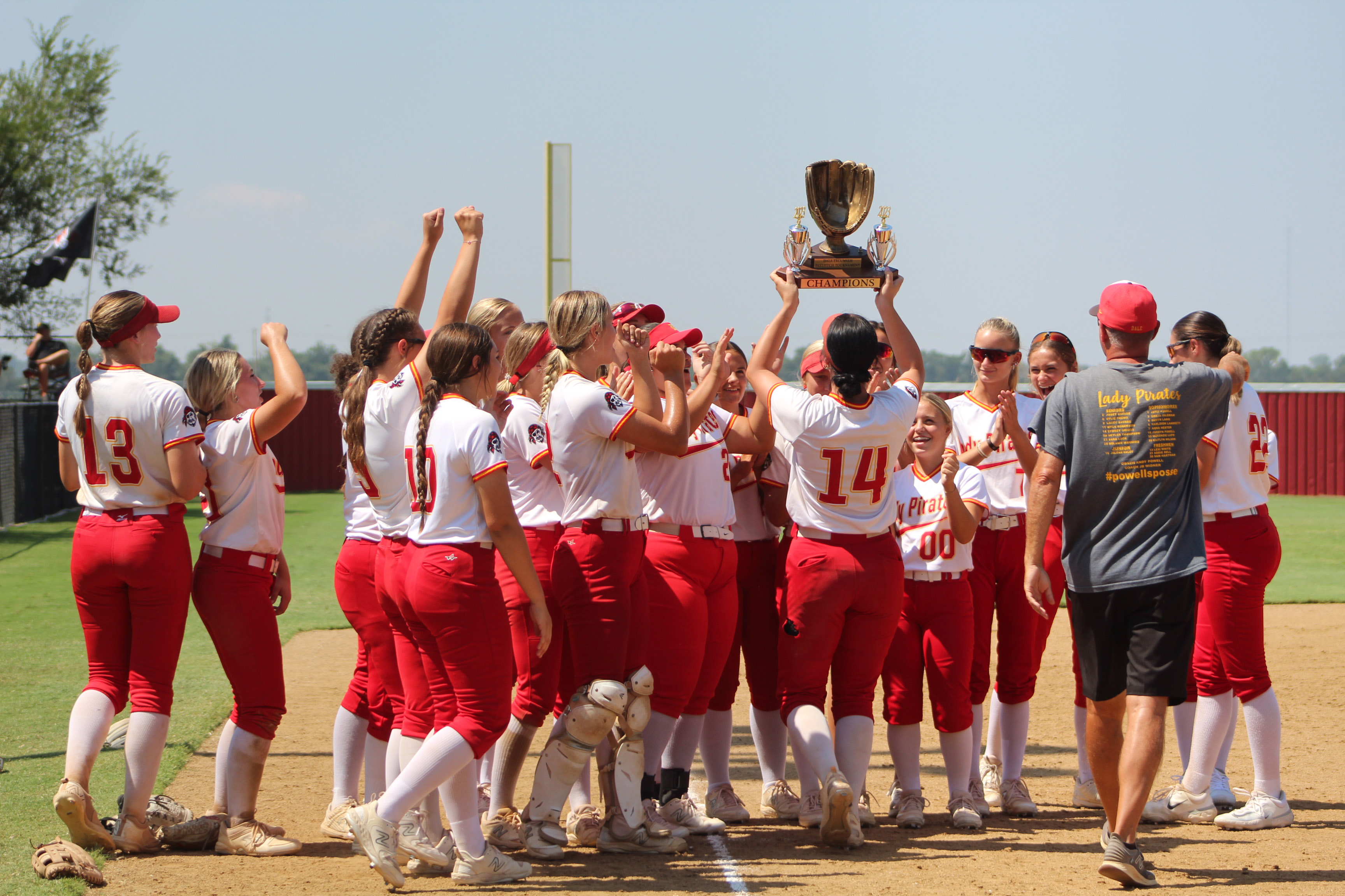 The Dale Lady Pirates celebrate after winning the Dale-Tecumseh Tournament on Sept. 9.