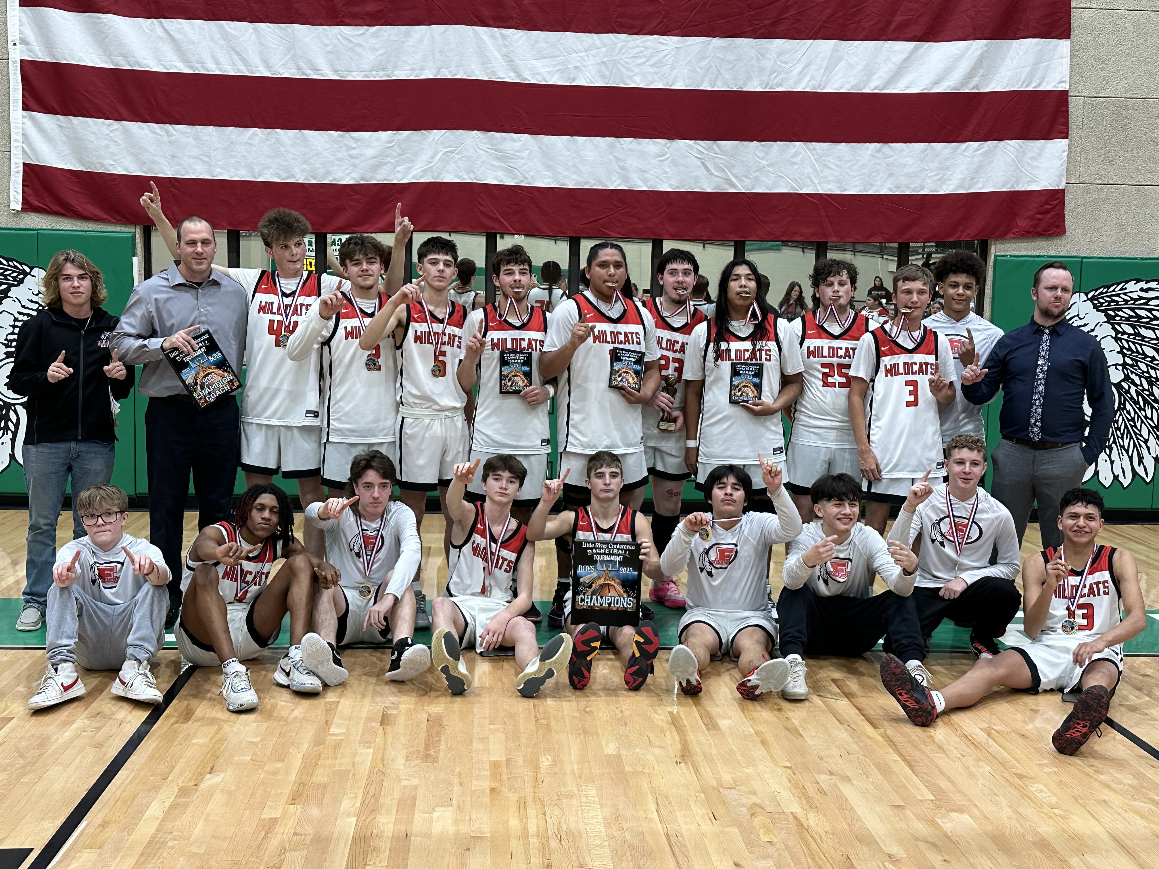 The Earlsboro Wildcats basketball team and their coaches pose with their plaques after winning the Little River Conference Tournament, held at Seminole High School, Dec. 5-9. They won all three of their games, beating Moss, 67-27; Mason, 68-38; and Varnum, 68-65, with a three-point buzzer beater. Photo provided by Coach Chad Rochelle.