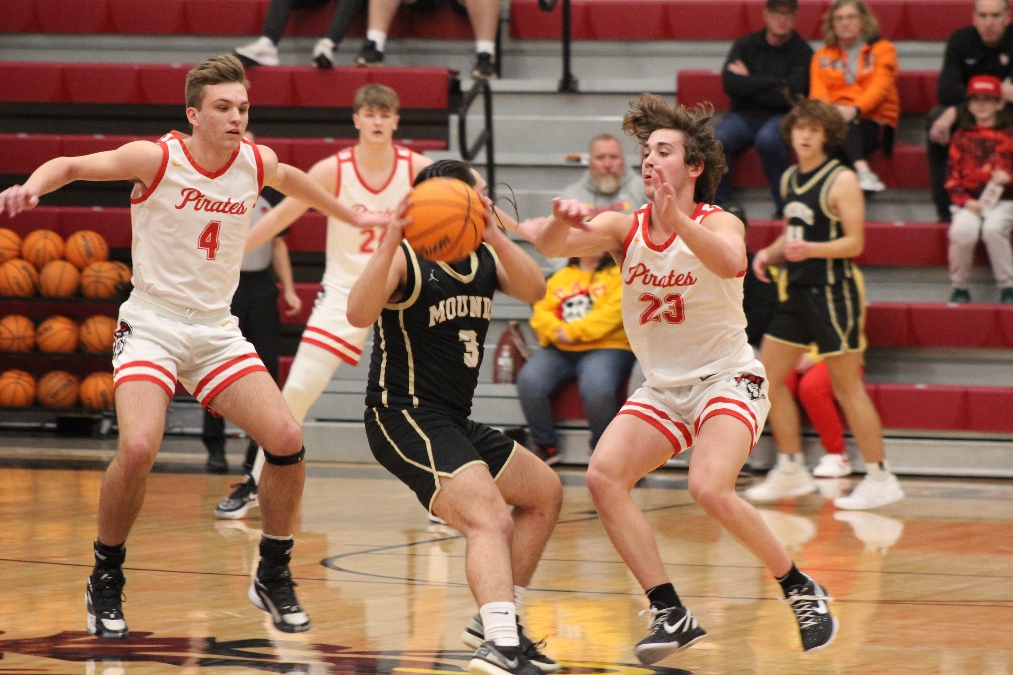 Dale's Jett Higdon (#4), Tray Chambers (#24), and Deken Jones (#23) defend the hoop during the Class 2A District game with Mounds, Feb. 17. The Pirates stomped Mounds, 90-37, and will play in regional competition at Dale today (Feb. 22) at 7:30 pm.  Countywide & Sun/Natasha Dunagan