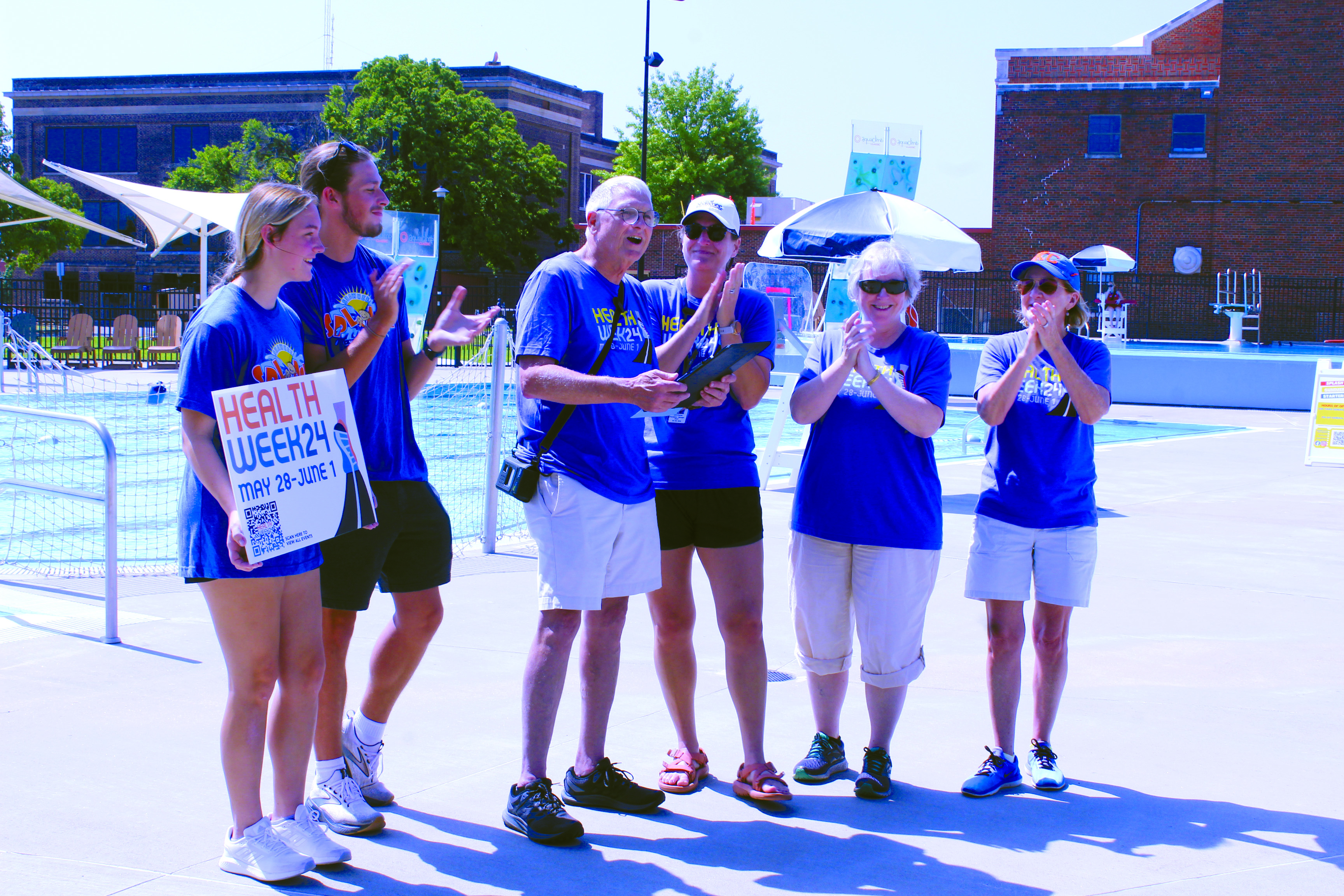 Shawnee Mayor Ed Bolt gets applause as he proclaims May 28-June 1 to be Health Week 2024 at the Shawnee Splash Water Park on May 25. Shown, from left, are Addison Williams, Austin Yates, Bolt, Kerri Foster, Amy Riggins, and Audrey Seeliger. The pool opened to the public for their 10th season on May 24, and Foster said they have several events planned. Visit the City of Shawnee website, or follow Shawnee Parks and Recreation or Shawnee Splash on Facebook and Instagram for more information.