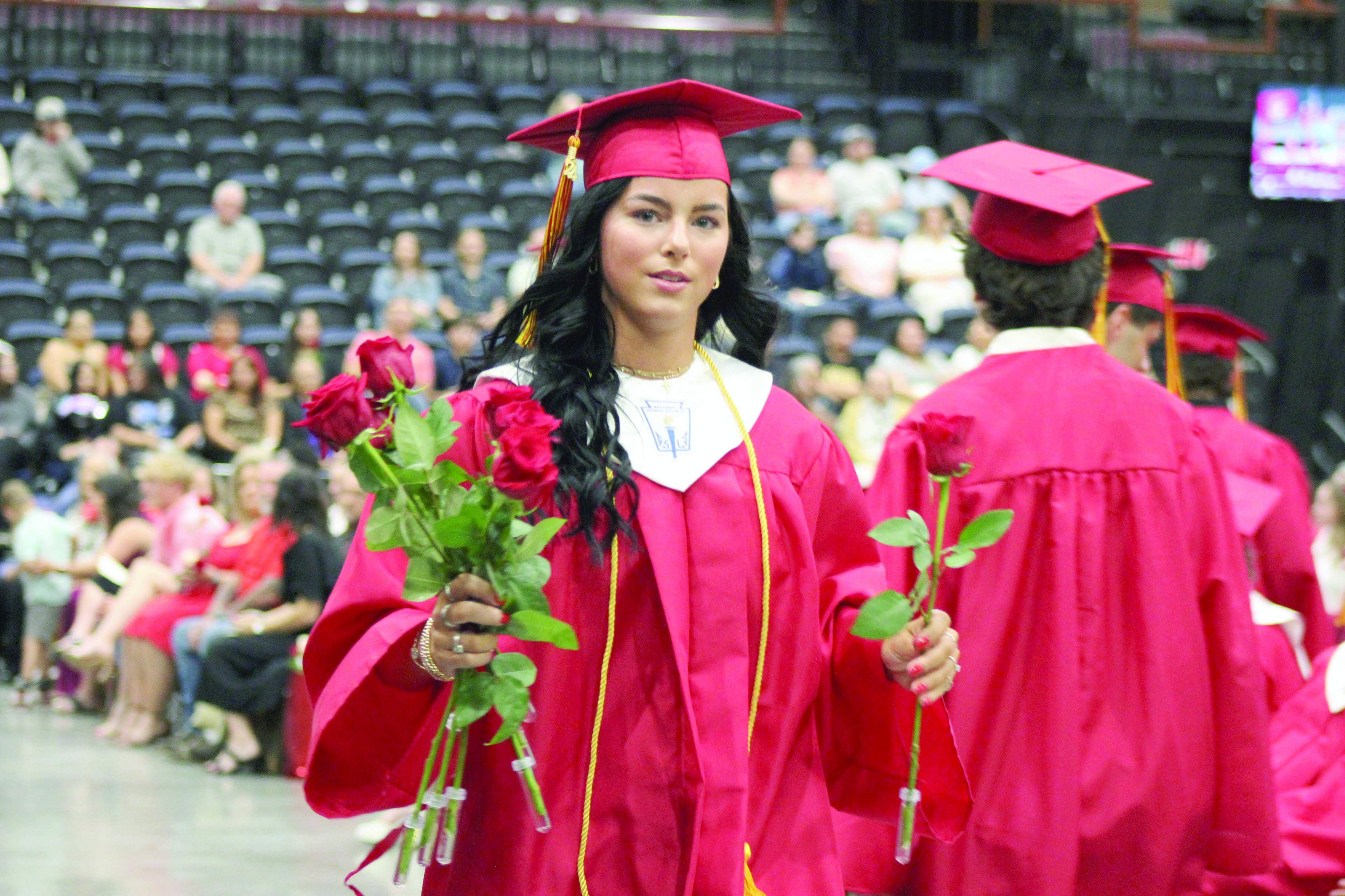 Dale Graduate Karsen Griggs delivers roses during the commencement program on May 13 at FireLake Arena. Countywide & Sun/Natasha Dunagan