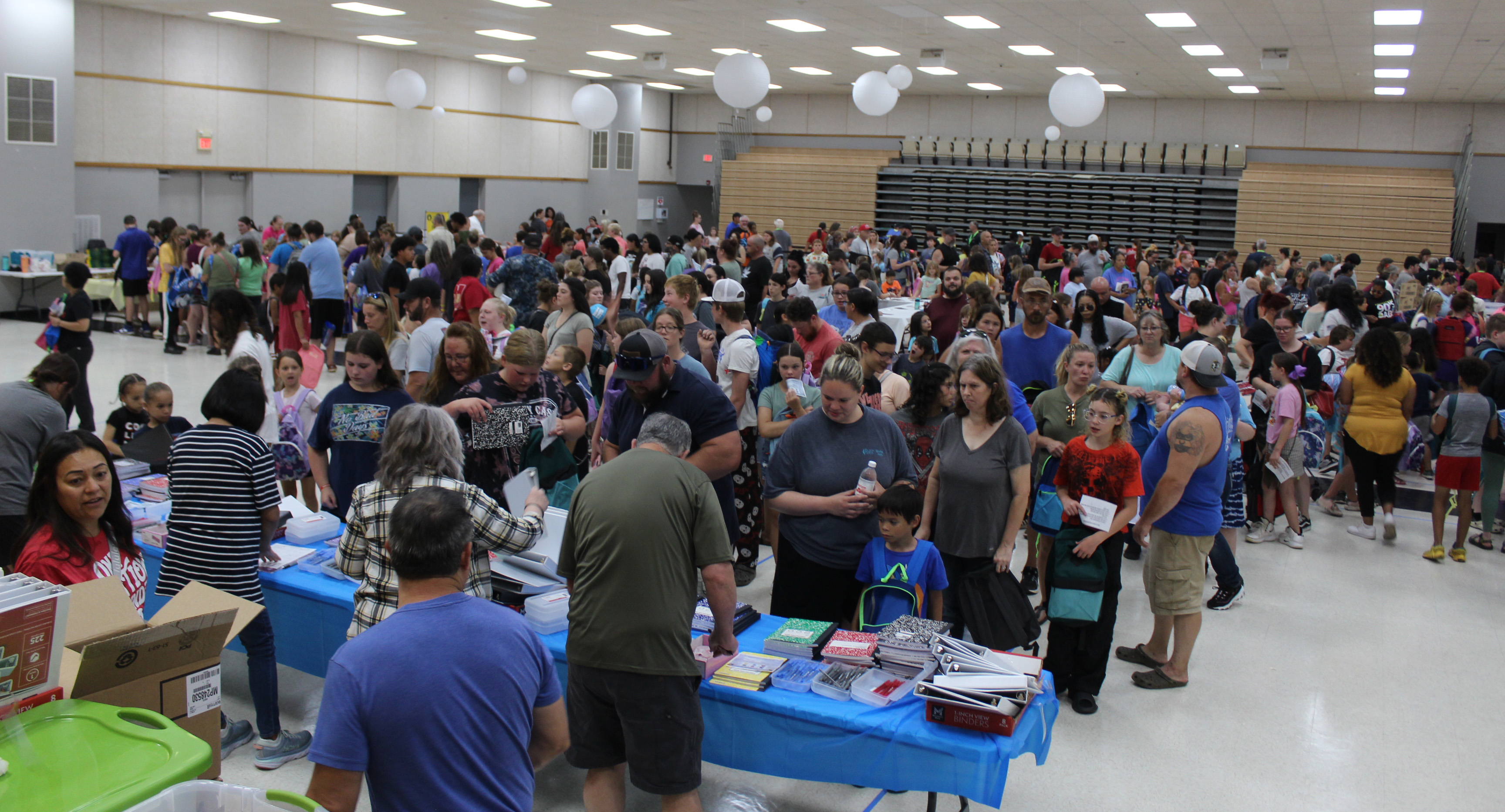 Families and students fill the WP Wood/THS Alumni Center waiting in line at eight stations for school supplies and backpacks on July 27 during the 10th Annual Mission Tecumseh Back to School Bash. Mission Tecumseh Board Member Anthony LaGrange said they gave away the 549 backpacks they had available in the first hour and continued to hand out school supplies until those ran out. Countywide & Sun/ Natasha Dunagan