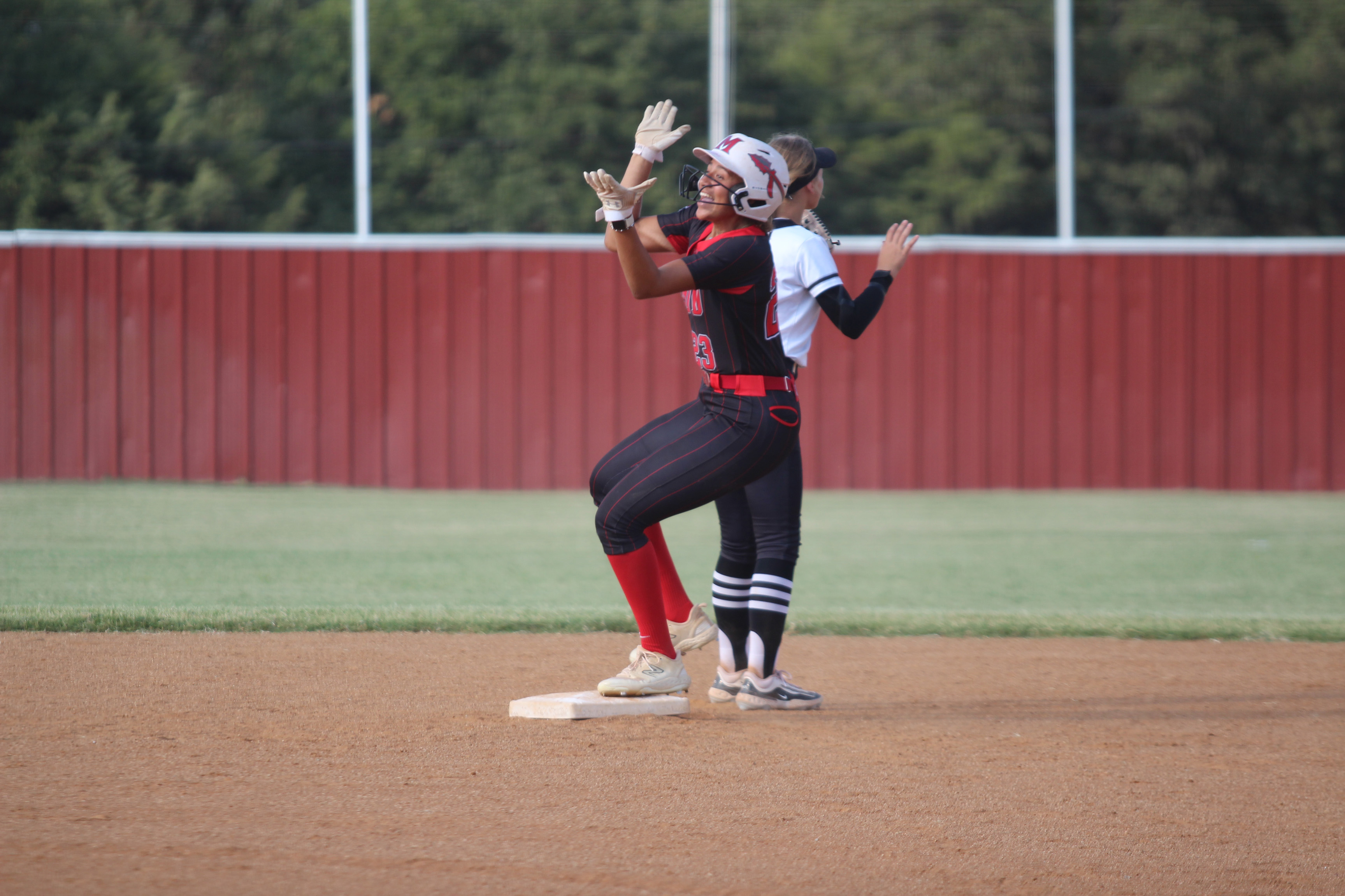 McLoud's Taycee Lewis celebrates after hitting a double during the fourth inning of the home game with Perkins-Tryon on Aug. 26. The Lady Redskins won, 13-6. Countywide & Sun/Natasha Dunagan