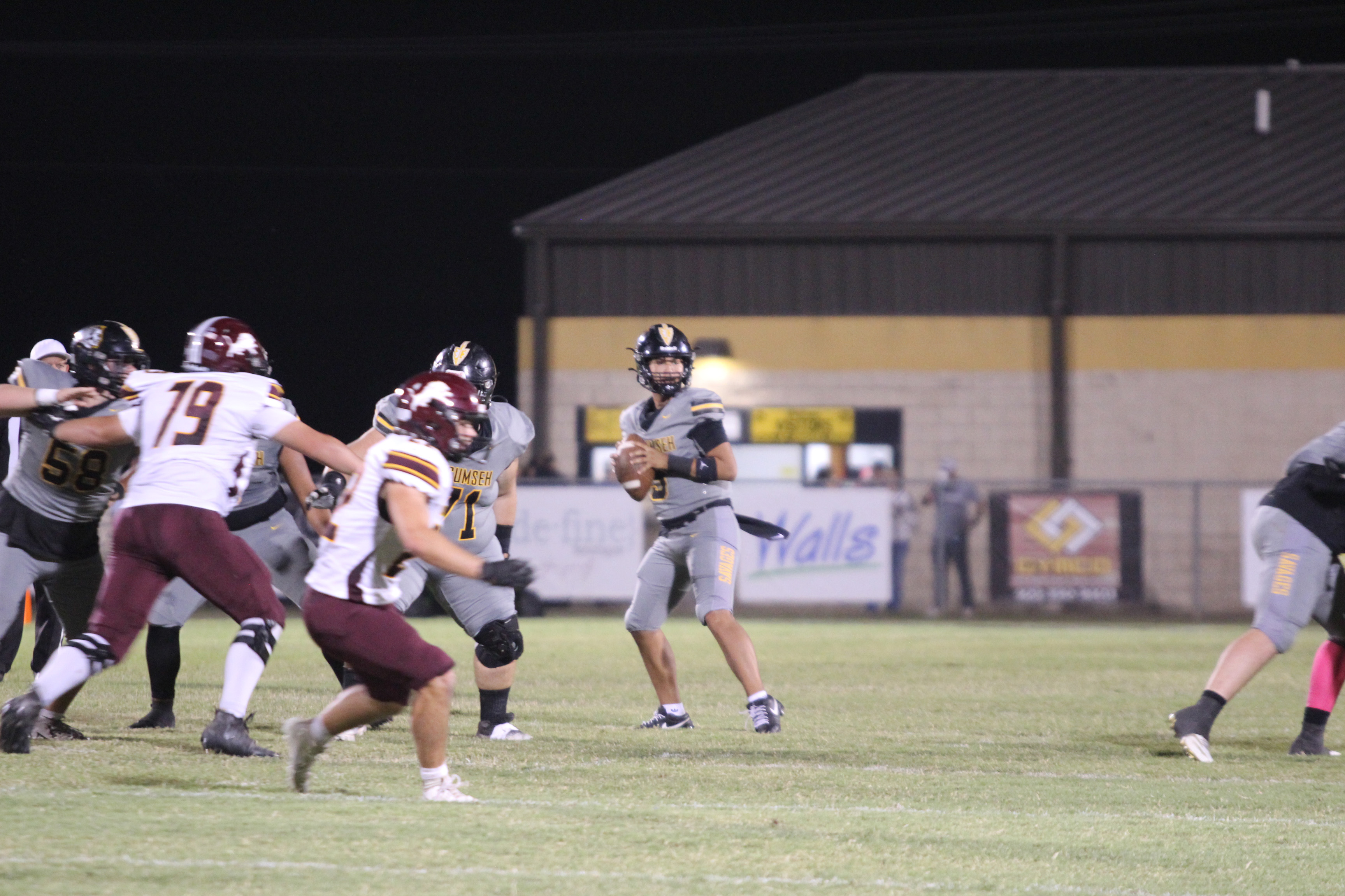 Tecumseh senior Hollin Barnes looks for an opening to pass during the second quarter of the Oct. 10 home game against Blanchard. The Savages lost, 7-34. Countywide & Sun/Natasha Dunagan