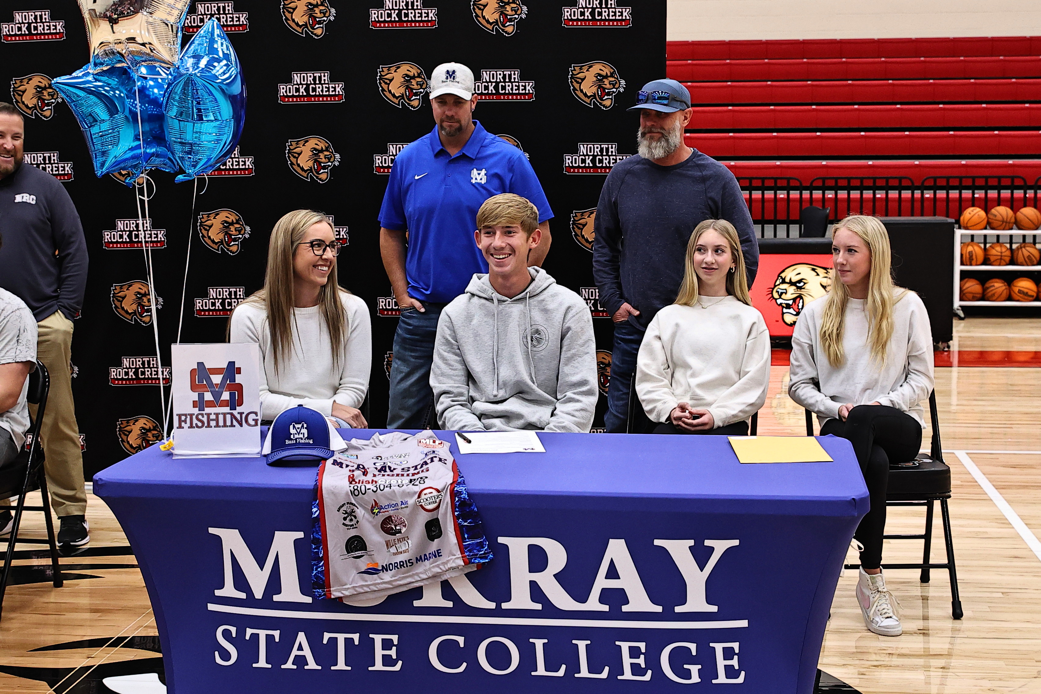 North Rock Creek's  Riley Motrych signed with Murray State College to fish for the college.  Watching him are his parents, Amber and Jason, sisters Kaylin & Savannah, along with the coach John Owen. Photo courtesy of Gowin Photography