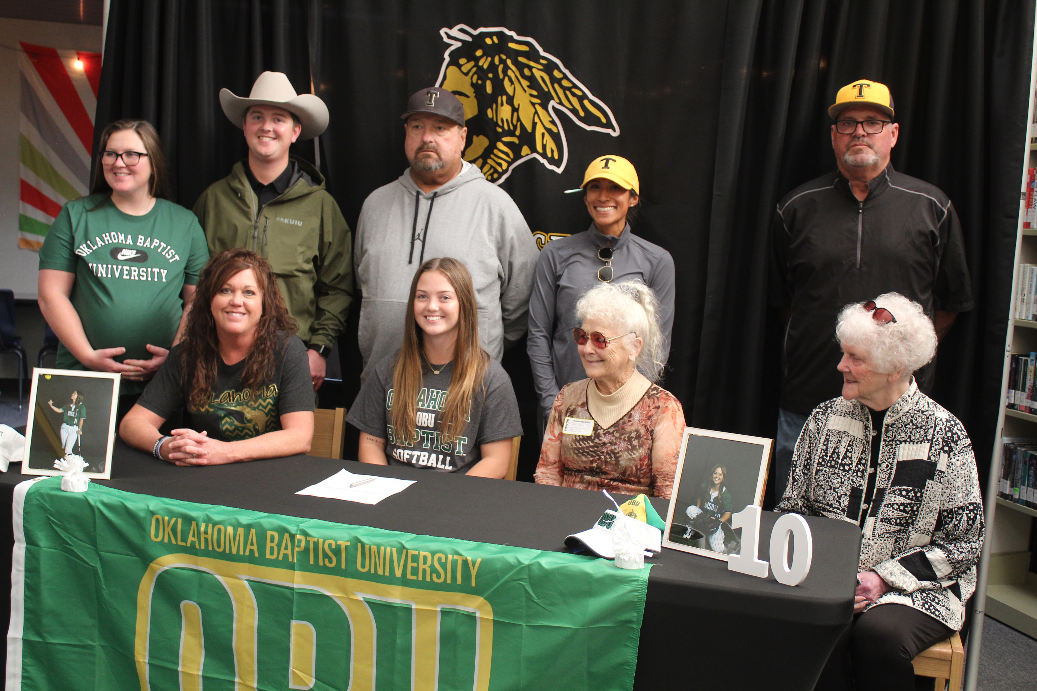 Tecumseh senior Jessi Hull signed a letter of intent with Oklahoma Baptist University for softball on Nov. 19. Shown, back row from left, are Hull’s sister, Franki Muirhead; brother, Augustus Hull; Coach Perry Wilson; Assistant Coach Kayla Rodriguez; and Coach Chad Trahan; front row from left, mother, Charli Hull; Hull; grandmother, Rose Hull; and, grandmother Yvonne Oliver. Countywide & Sun/Natasha Dunagan