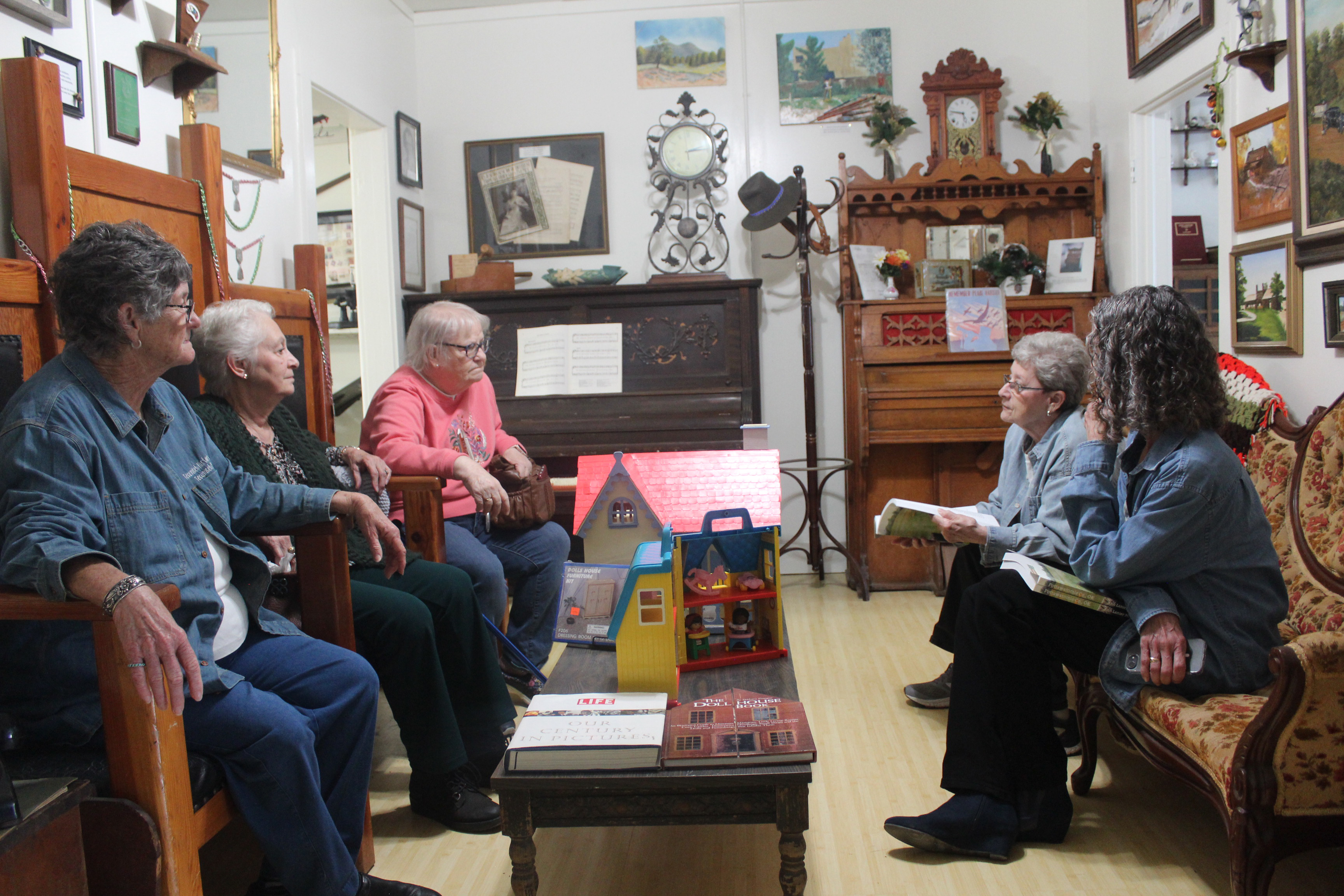 A group of Tecumseh Museum volunteers and visitors sit in the Glenn Dale Carter room for conversation during the museum's 30th anniversary on April 19. Shown, clockwise from front left, are Jan Parker, Shannon Garrison, Ann McDonald, Jane Fleming and Ruth Beasley. The museum plans to host tours for Tecumseh fifth-graders this week. Natasha Dunagan, Countywide & Sun