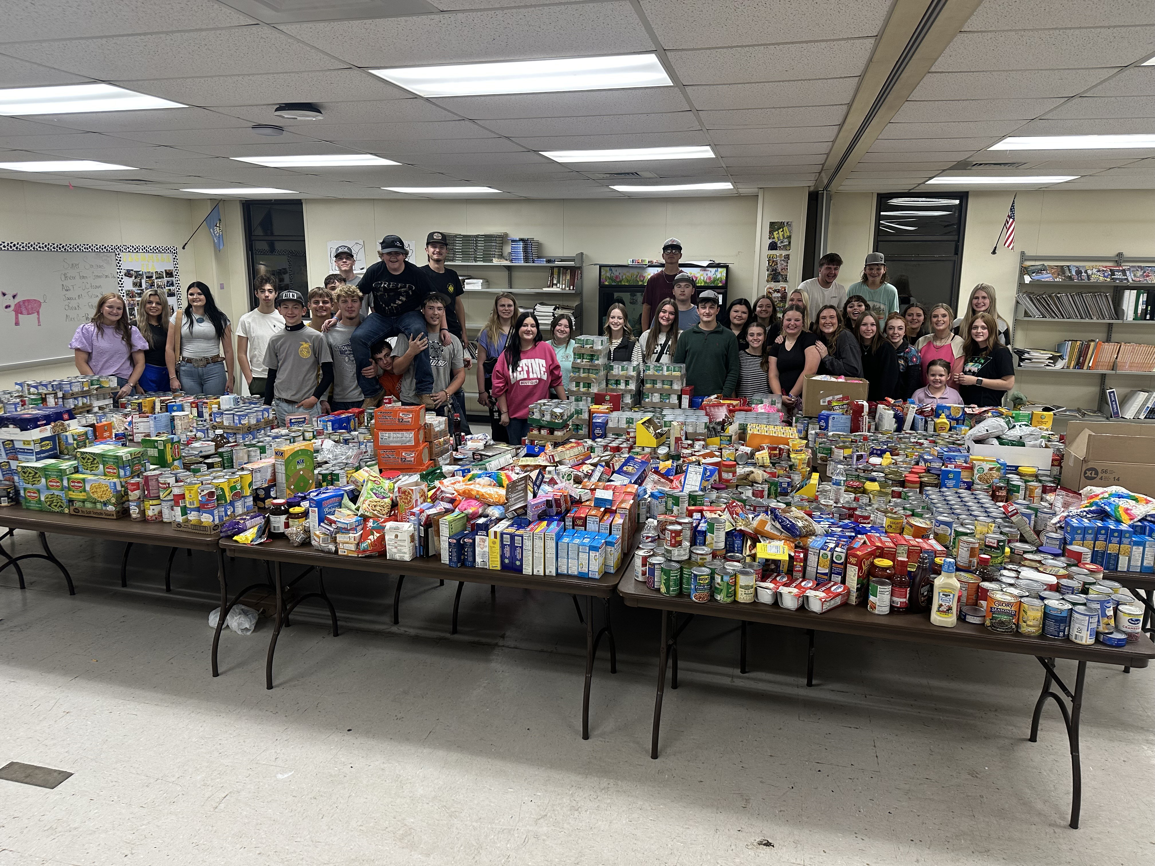 Tecumseh FFA members pose after collecting a record-breaking 3,736 items in one hour from the community during their Food Drive Scavenger Hunt on Nov. 13. The non-perishable food was distributed  between the Highland Church of Christ Food Pantry and Tecumseh School Food Pantry. Photo provided.