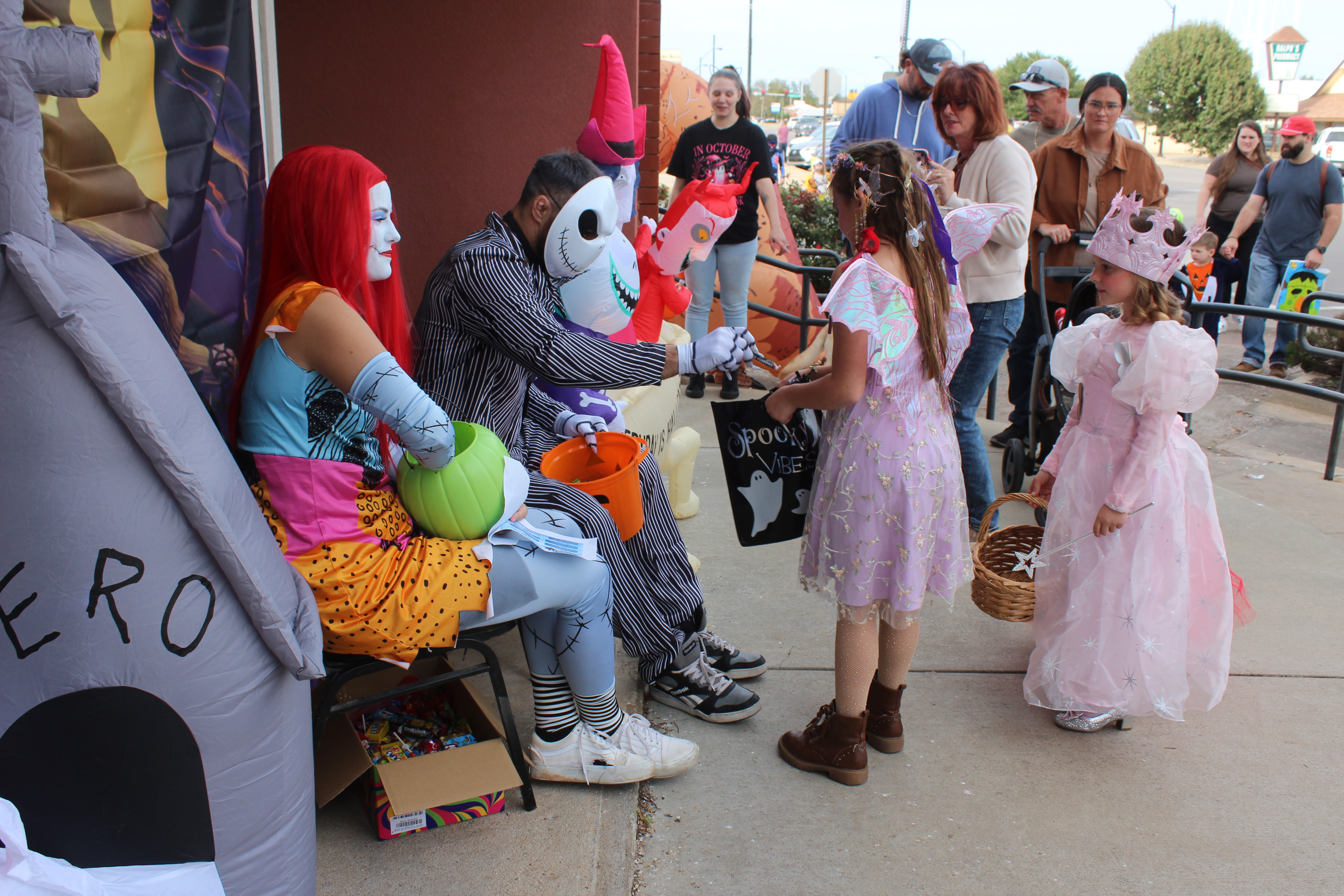 Dressed as characters from "The Nightmare Before Christmas," Maggie and Brian Grinnell with Clarity MMA hand out candy to a fairy and a princess during the Tecumseh Business Treat 'r Treat on Oct. 31. 