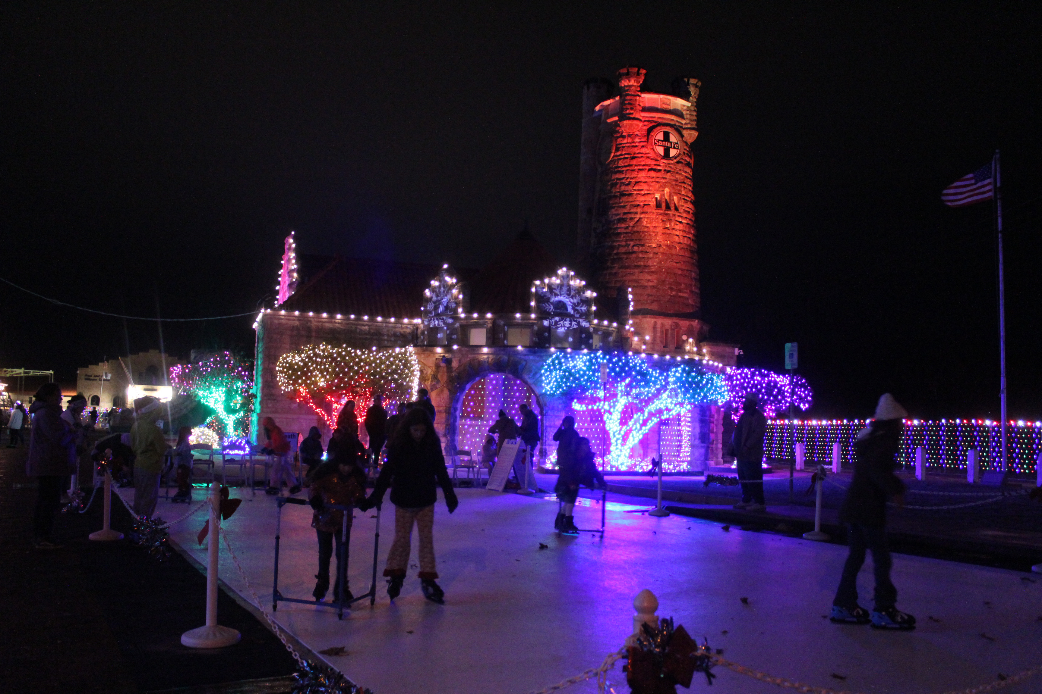 Several children and teens enjoy the ice-skating rink made of synthetic ice in front of the Santa Fe Depot in Shawnee during the Safe Events for Families "Winter Wonderland" on Nov. 28. Oklahoma Representative Dell Kerbs, with SEFF, said they had about 1,000 visitors to the free event in their opening weekend. Kerbs added that ice skates are available for those who need to borrow them. See full cutline below.