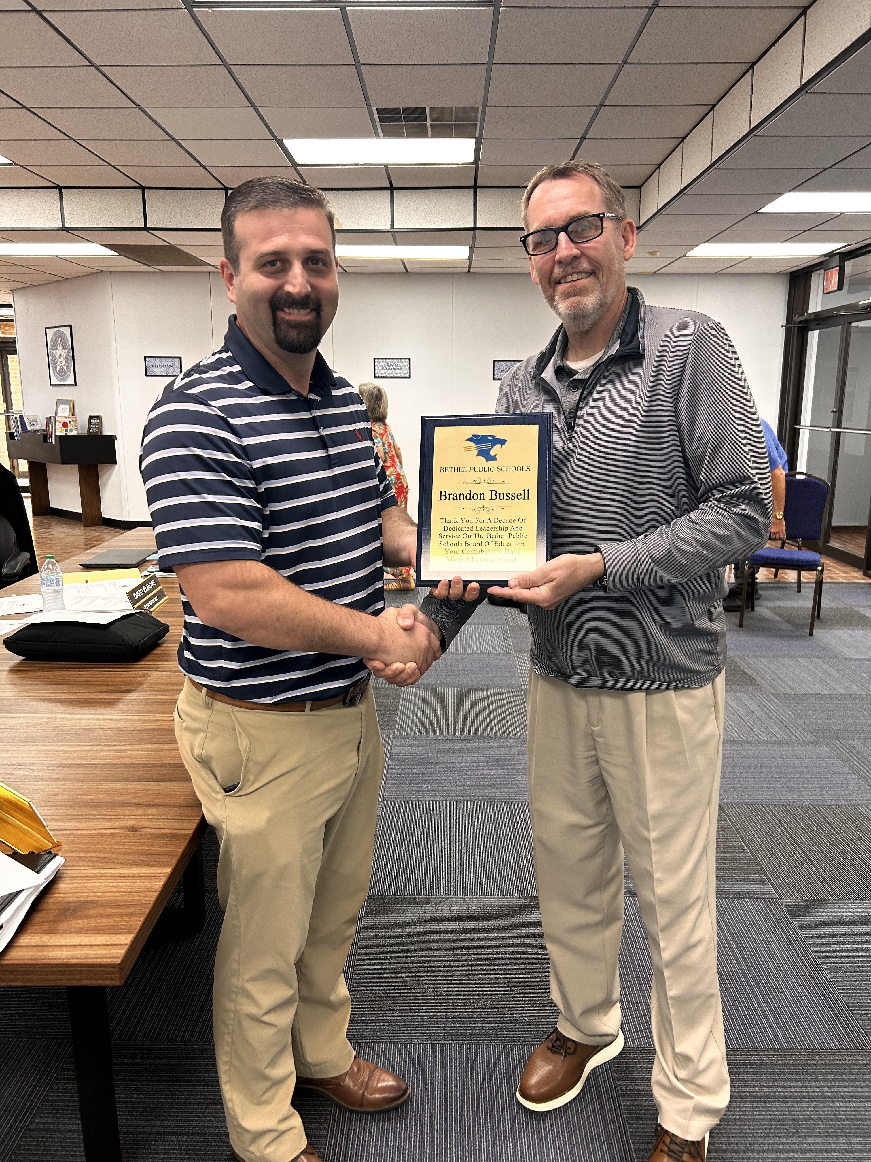 Brandon Bussell (pictured left) is presented a plaque by Superintendent Dr. Matt Posey (right) for his 10 years of service on the Bethel School Board. Suzie Campbell, Countywide & Sun