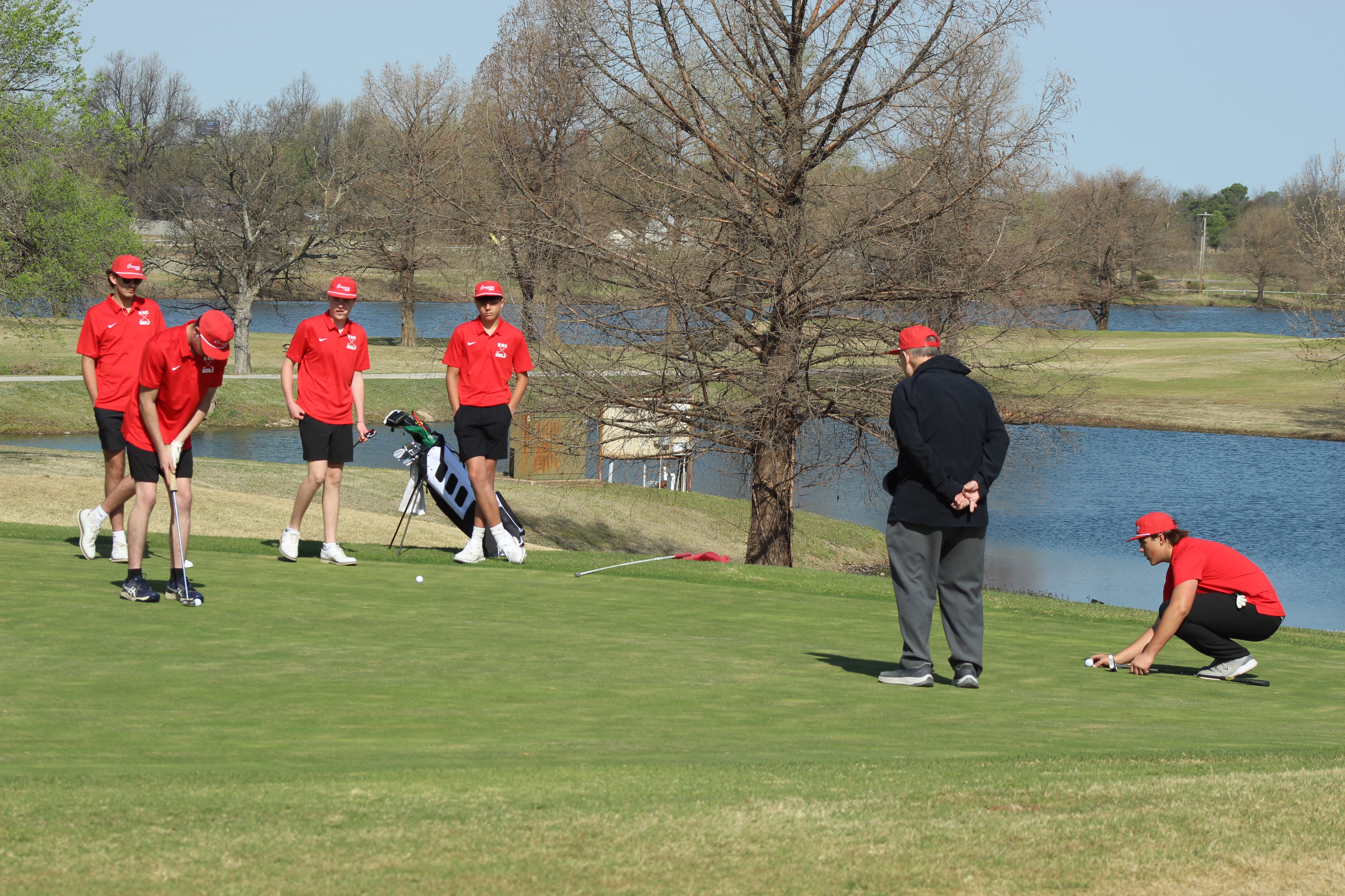 The North Rock Creek Cougar JV golf team is shown at the ninth hole during the North Canadian River Valley Conference Tournament, held at the Elks Golf Course in Shawnee on March 24. They are, from left, Parker Ramsey, Maddox Taulman (putting), Carson Simmons, Haygen Eubanks, Assistant Coach Don Sumner and Ryder Adams. Tecumseh, Bethel and McLoud also participated in the event, and the NRC Lady Cougars placed first as a team, according to a Facebook post on the NRC Public Schools page.
