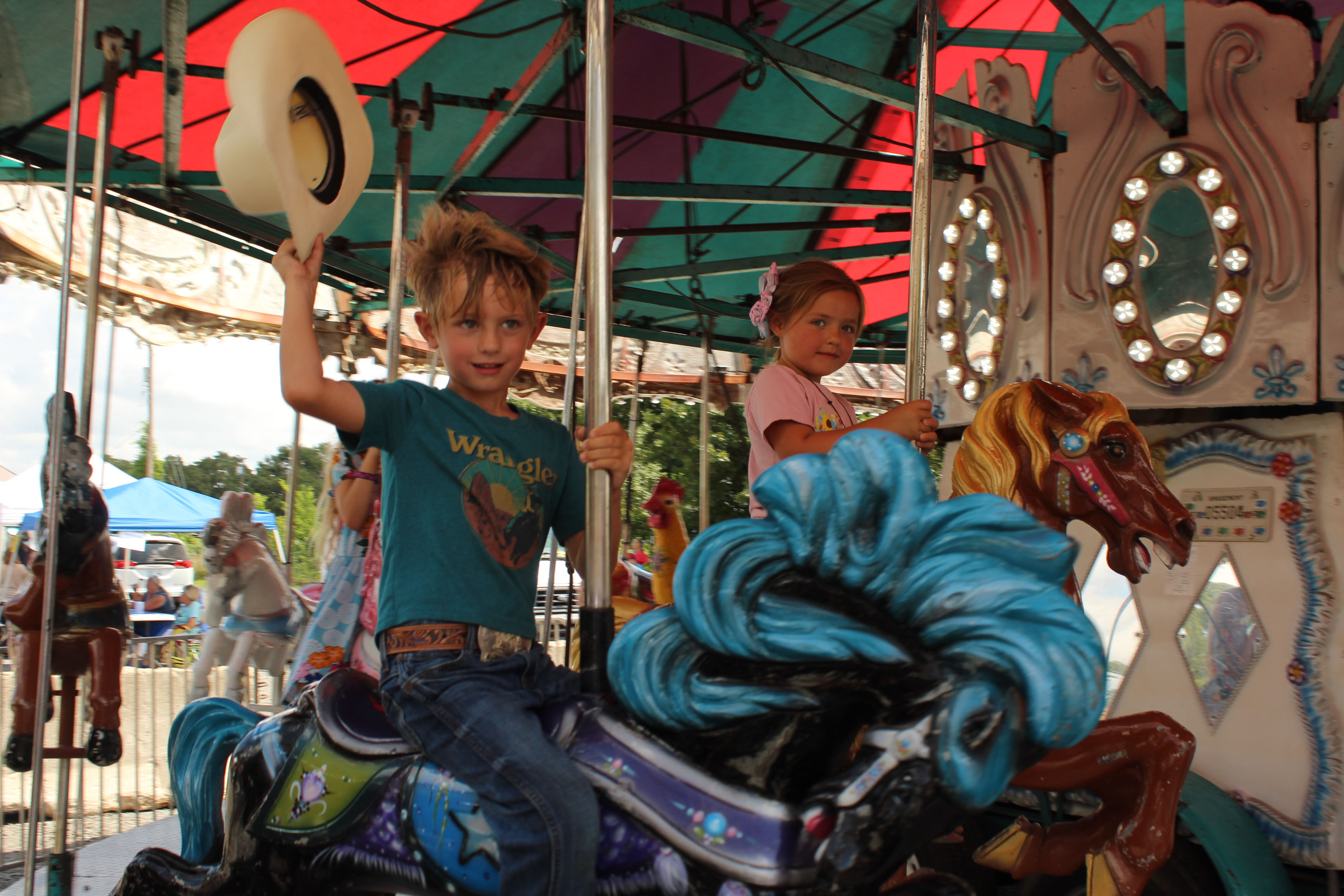 Clyde Hamlin, 5, of Tecumseh, and Callie Luck, 3, of Shawnee, ride on the carousel at the 131st Annual McLoud Blackberry Festival on June 20. The two-day festival also featured vendor booths, live music, kids games and a parade. Photos by Natasha Dunagan, Countywide & Sun