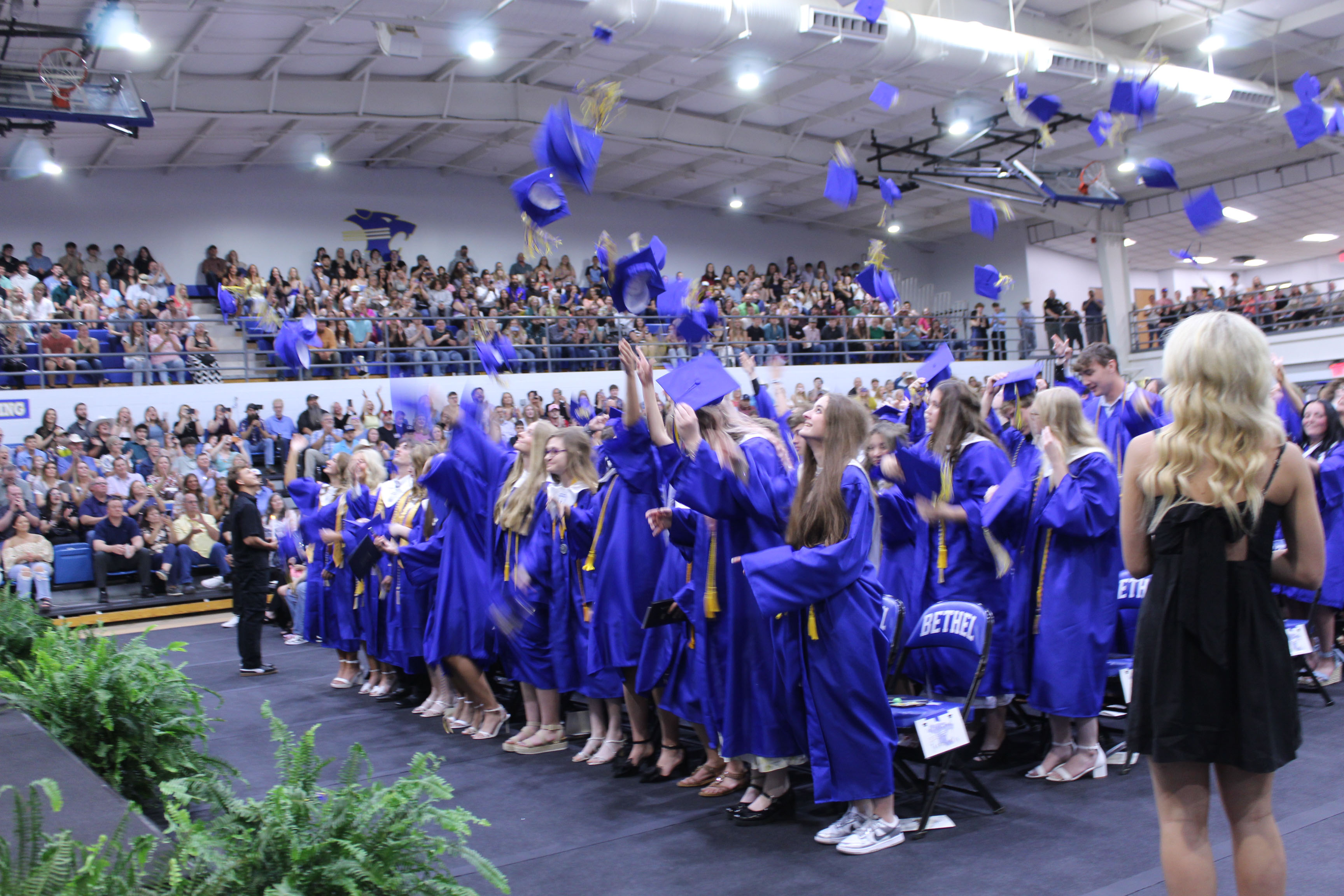Bethel High School's Class of 2026 toss their caps after graduating on May 16 in the BHS gym. Bethel graduated 81 seniors this year.