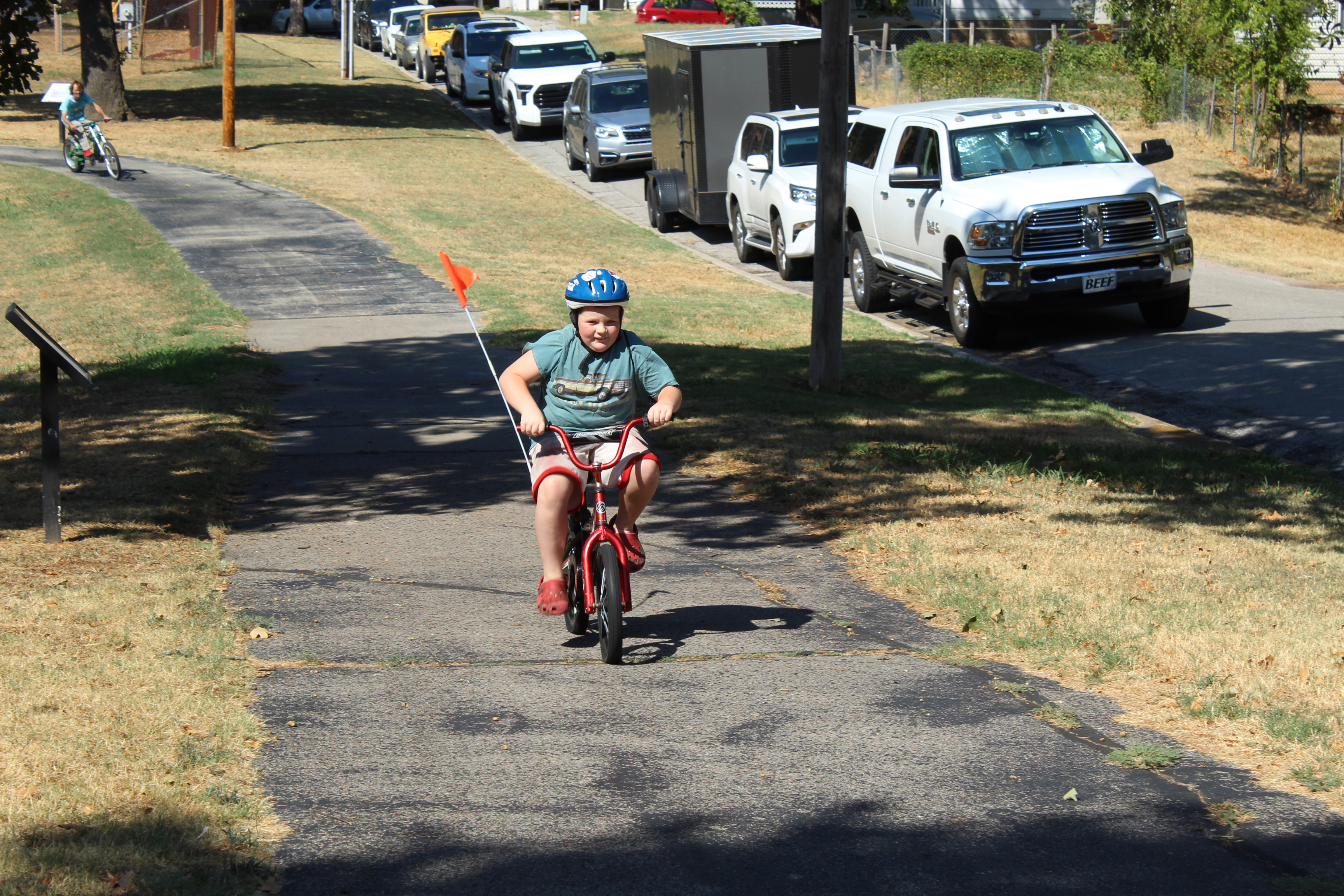 Jasen Emery, 8, of Shawnee, has fun on his bike in the community bike ride during the Pottawatomie Go Pedal Palooza, held at Rotary Briscoe Boy Scout Park on Sept. 19. About 40 people rode around the park and were rewarded with goodie bags and happy face fans from Oklahoma Mobility Management. Horace Mann Elementary Principal Christi Lovelady led the ride, along with George Wright from CPN and Ryan Brooks from Uplift Mentoring.