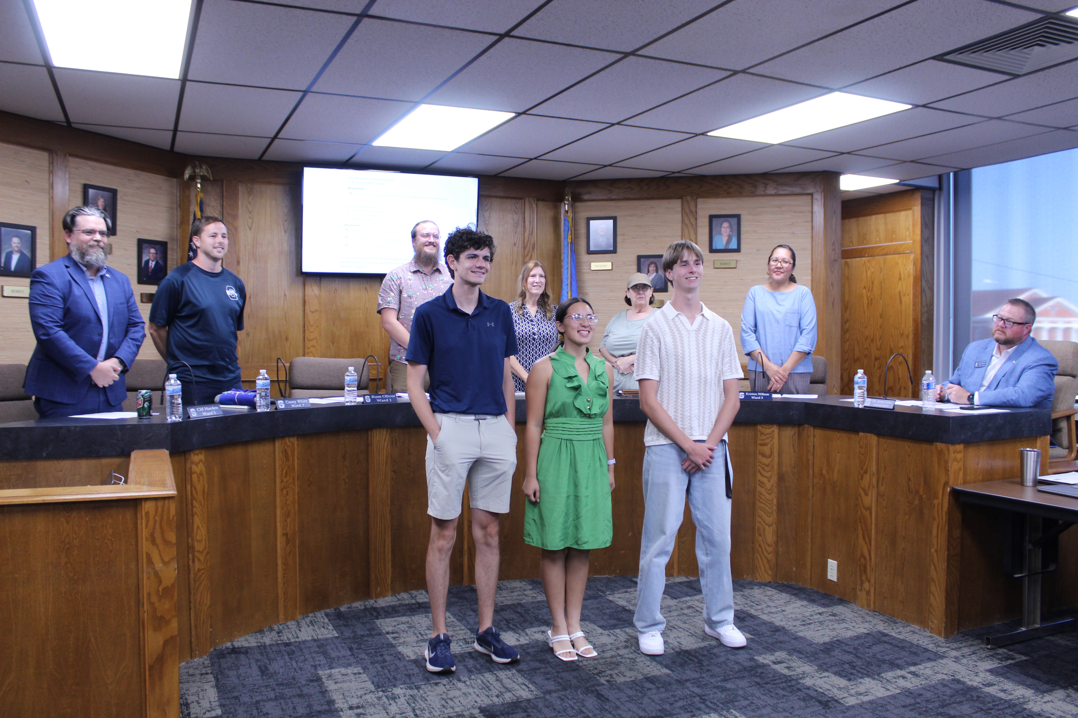 National Merit Scholars semifinalists Cooper Dunn, Kimberly Albers and Anthony Newsom pose with the Shawnee Board of Education during the Sept. 14 meeting. The Board, from left, are Clif Harden, Casey White, Turner Bass, Jeanne Swinney, Mandy Hillhouse and Kristen Wilson, with Superintendent Dr. Jason James, far right. (Board member Russ Oliver was not present.) Photos by Natasha Dunagan, Countywide & Sun