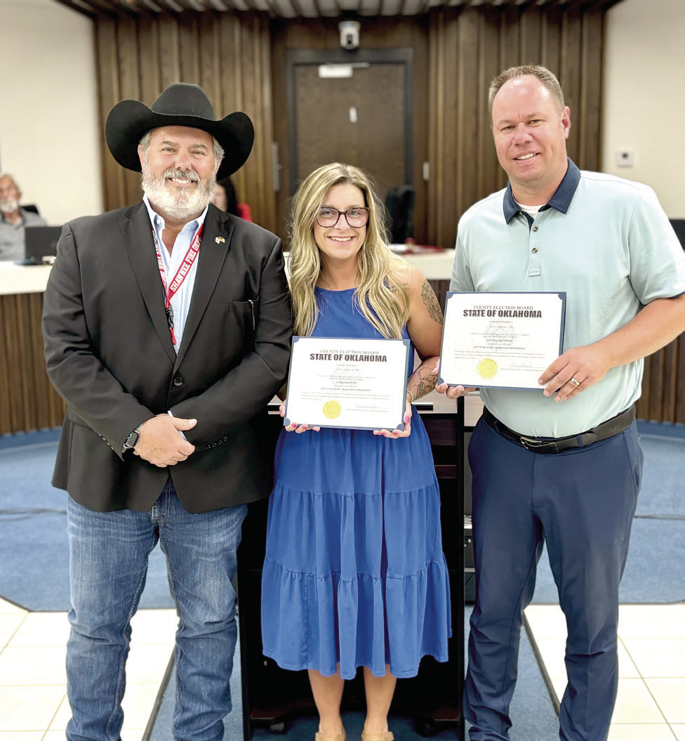 Shawnee Mayor Eric Stephens poses with re-elected commissioners, Lauren Richter (Ward One) and Daniel Matthews (Ward Six) after their swear-in at the July 20 City Council Meeting. Photo provided.
