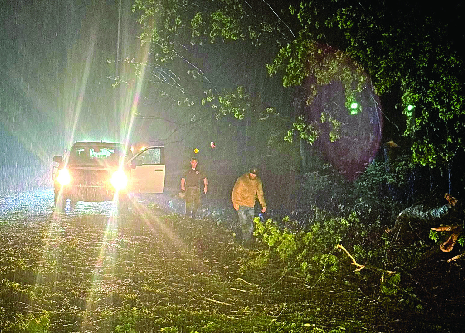 Emergency Management Director Aaron Scott (right) and Sheriff Freeland Wood begin clearing roads immediately following the storms April 3. Photo provided by Pott. County Emergency Management