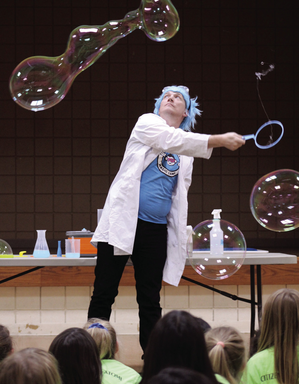 Professor Bucket, aka Joe Coover, with Funky Monkey Magic demonstrates how to make large bubbles, with the help of guar gum and spraying mist in the air, during the 'Bubble Party' at Tecumseh Public Library on July 31. Natasha Dunagan, Countywide &amp; Sun