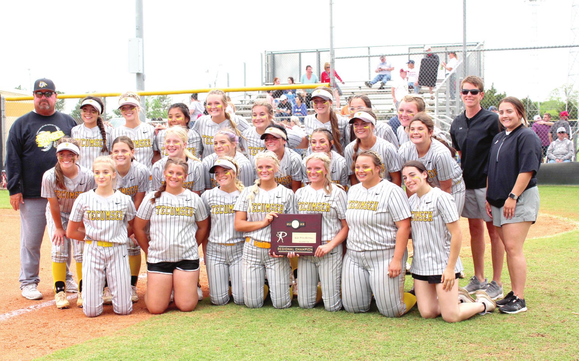 The Tecumseh Lady Savages Slow Pitch team, with their coaches Perry Wilson and Amy Shelby, pose with the Class 5A Regional Championship trophy following their home game against Cache on April 28. They won that game, 3-1, and the earlier game with Harrah, 8-0. Countywide &amp; Sun/Natasha Dunagan